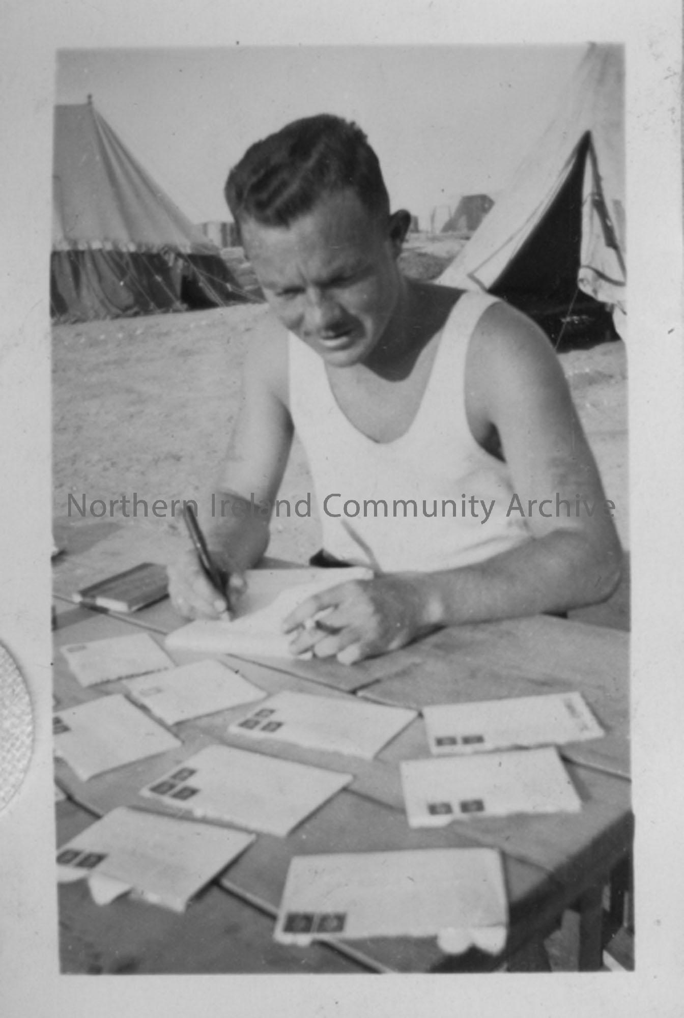 R McDonald sorting his mail tents in background