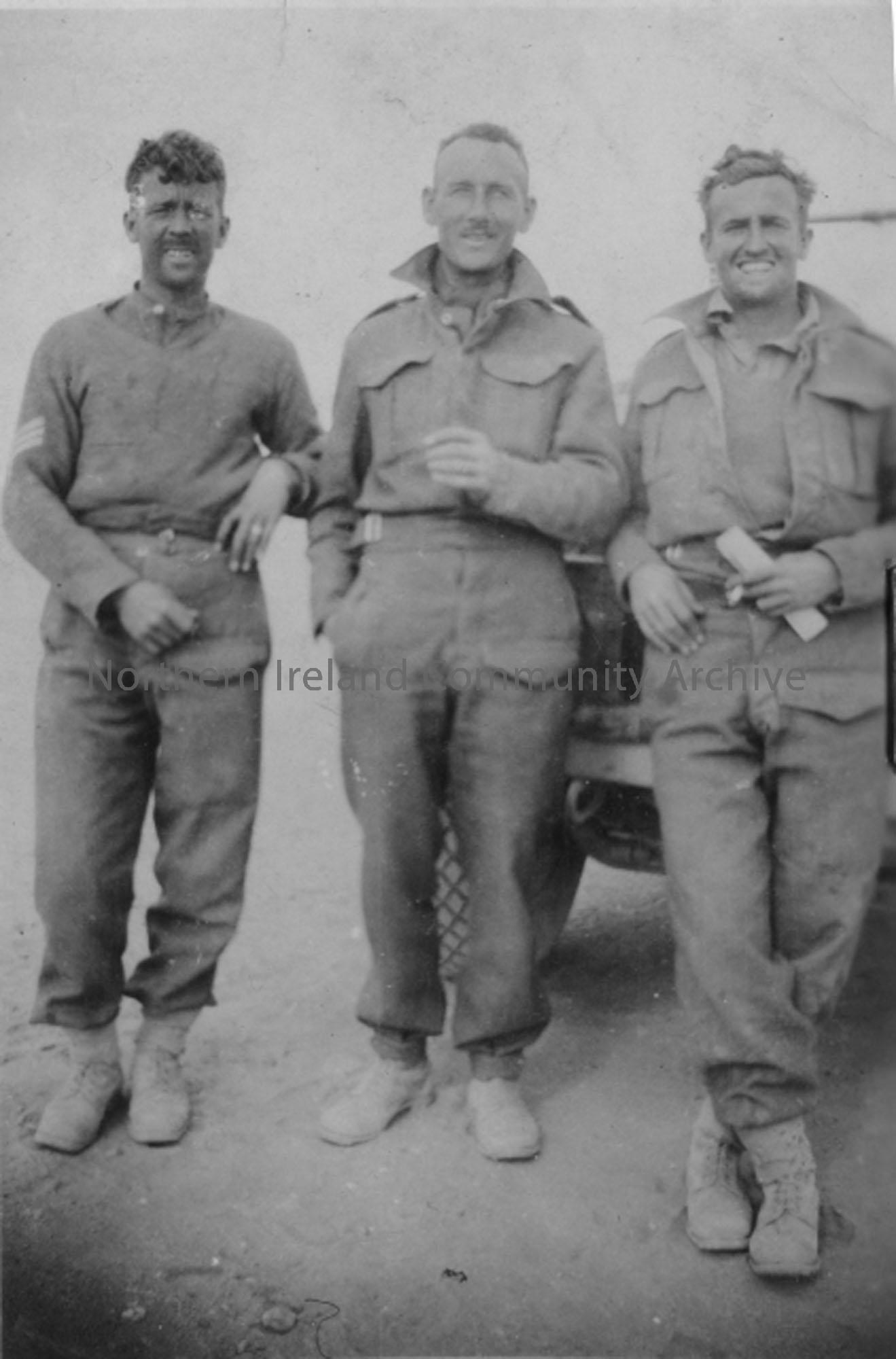 Three gunners in front of vehicle