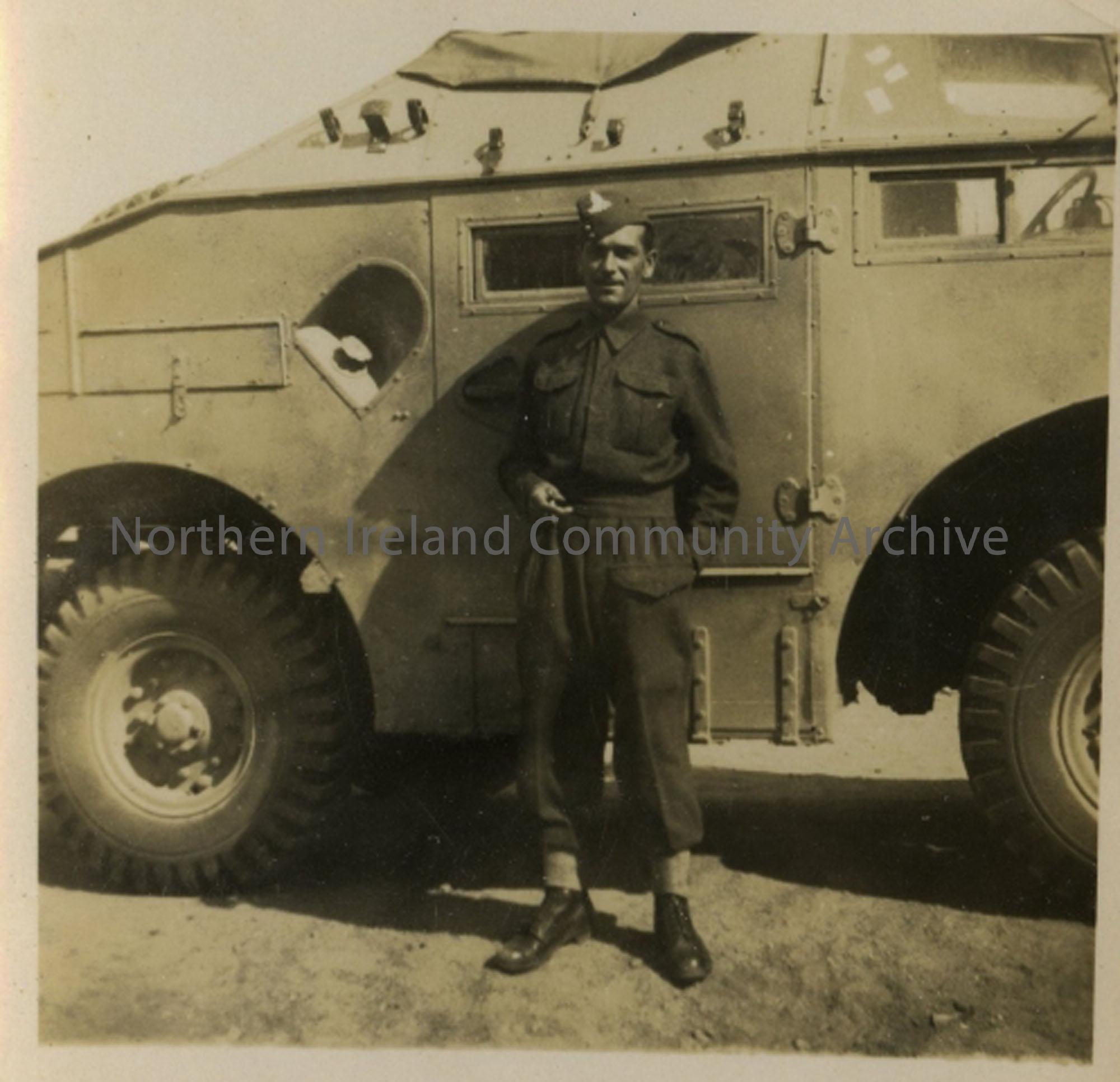 Soldier standing beside quad vehicle