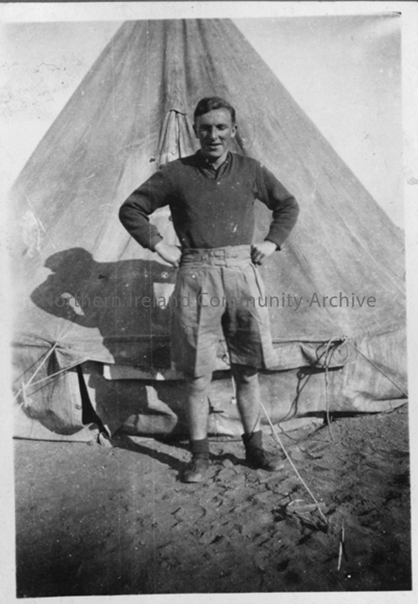 J Robinson Hands on hips outside his tent on Suez Canal