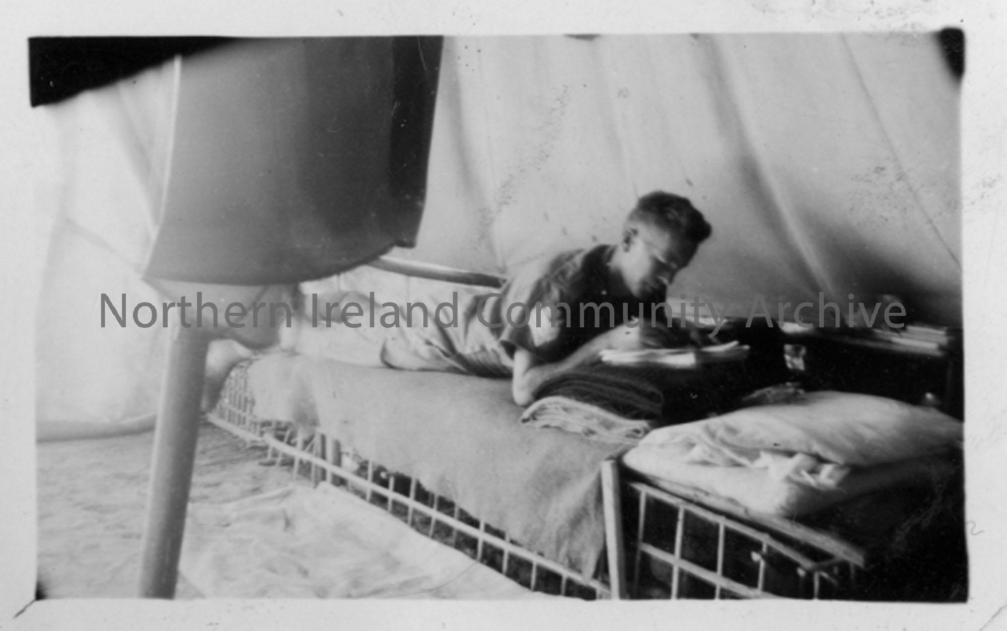 Sgt W McDonald in bed in tent