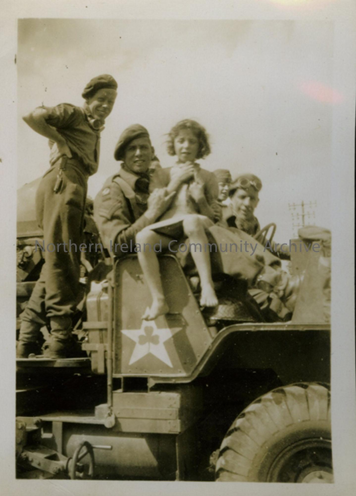Soldiers and girl in vehicle