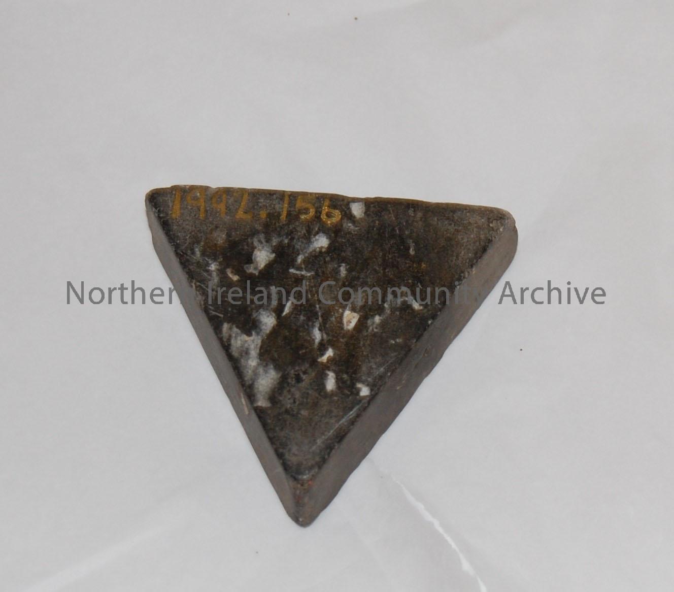 Grey coloured triangular shaped ink well with curved indentation. – 1992.156