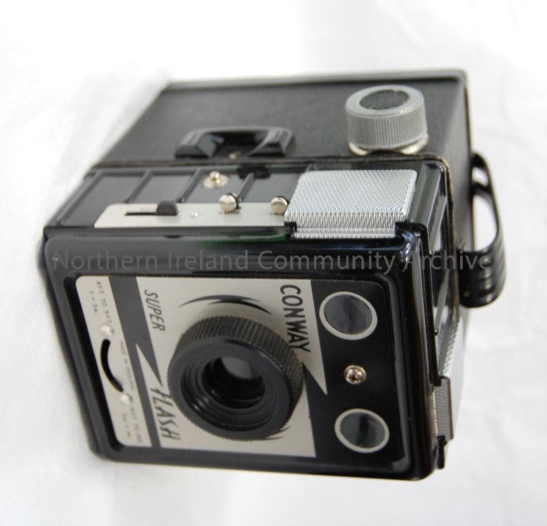 Conway Box camera (rare model) with flash sockets in brown case. Bought in Ballymena about 1949/1950. 21×31 in negatives, 120 roll film. – 2010.506