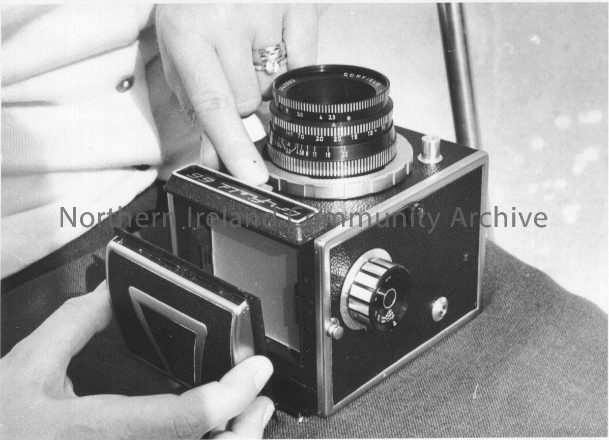 Photographs of a Corfield 66 camera modelled by Pat Williams. – 2011.265 (10)