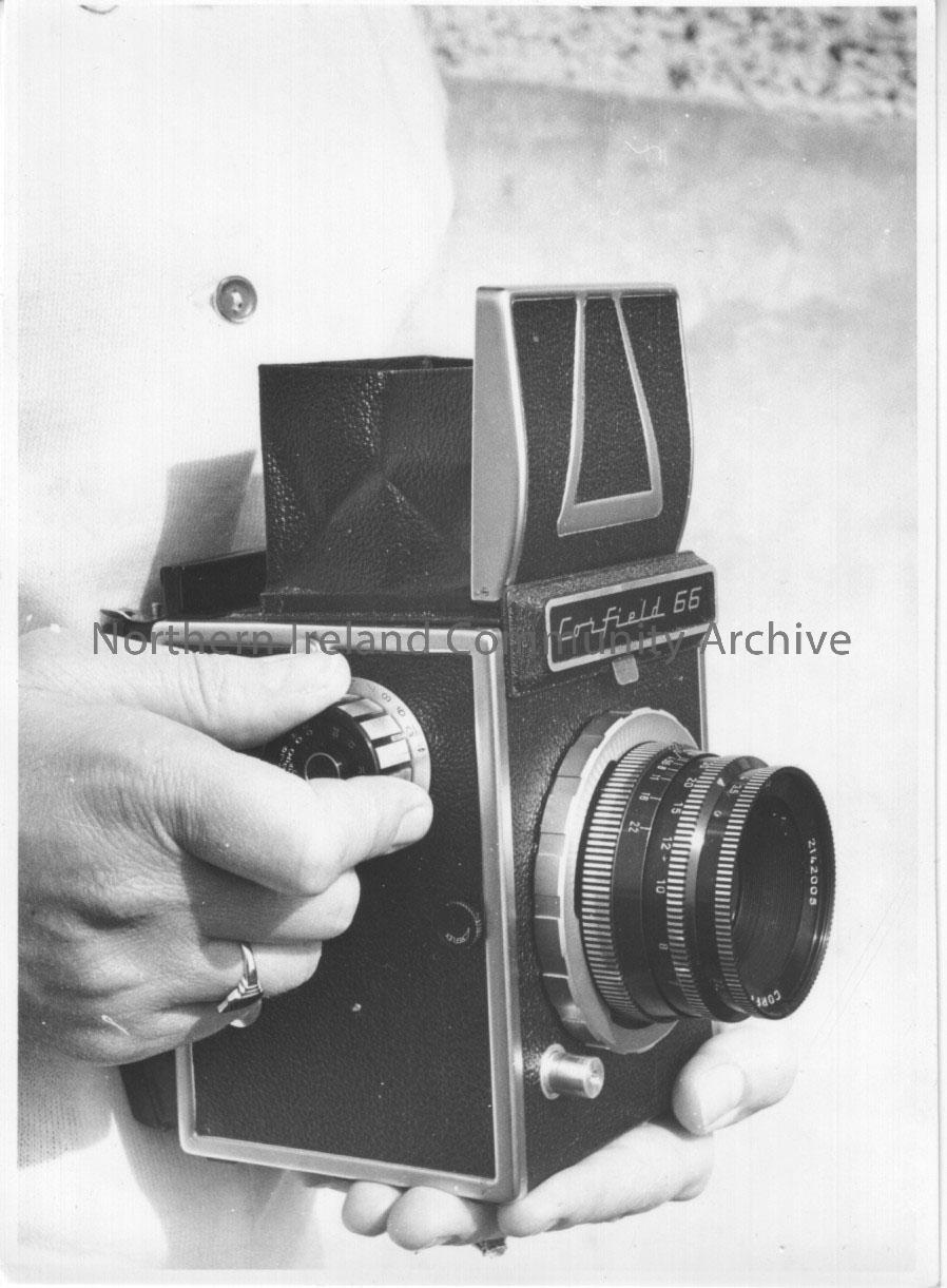 Photographs of a Corfield 66 camera modelled by Pat Williams. – 2011.265 (7)