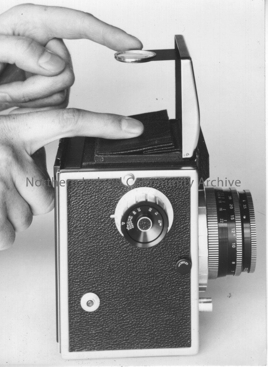 Photographs of a Corfield 66 camera modelled by Pat Williams. – 2011.265