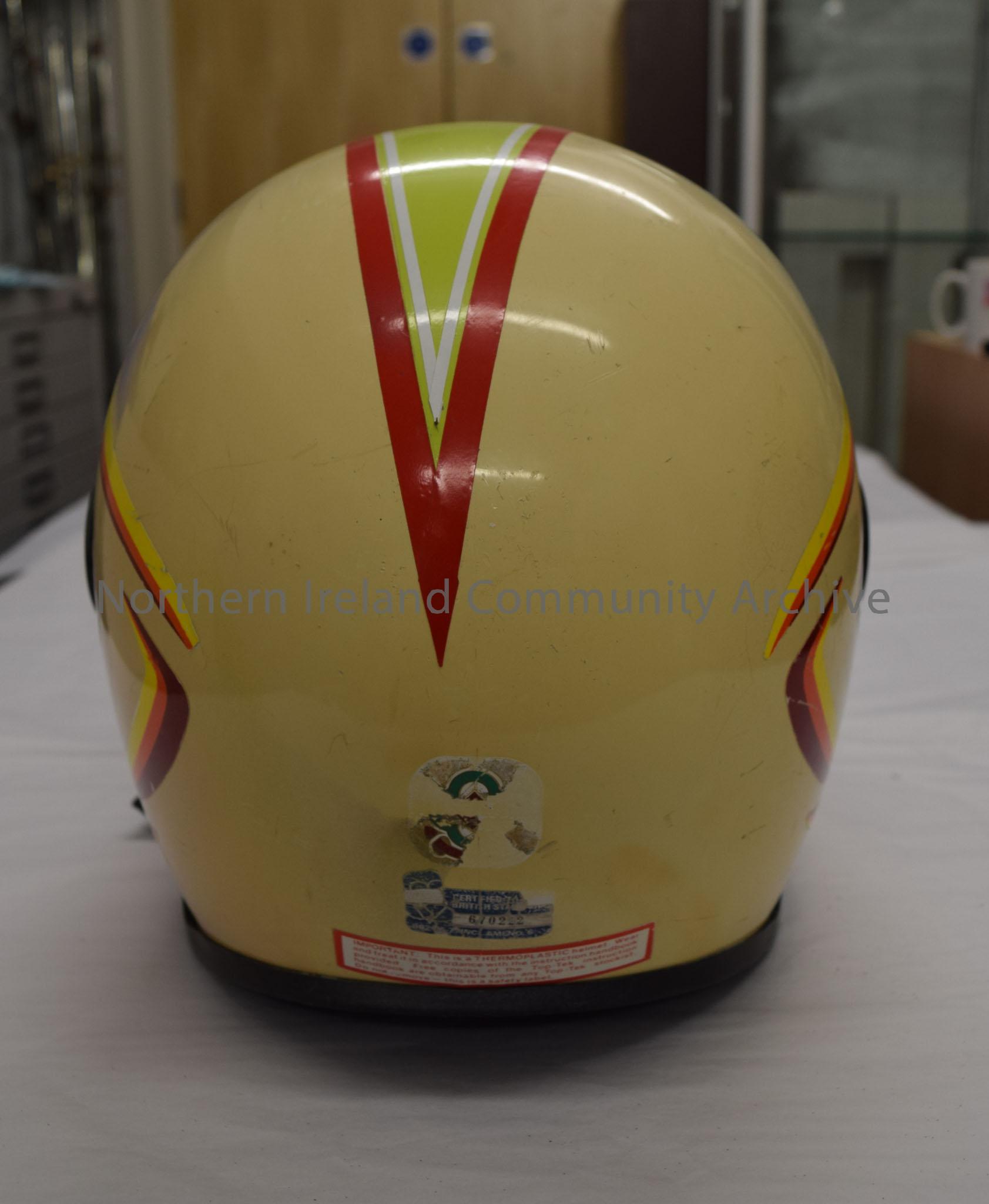 Top Tek motorcycle helmet. Cream with green/yellow stripe down the middle with a red border and red T in the centre. Yellow, red and burgundy stripes … – 2016.10 (4)