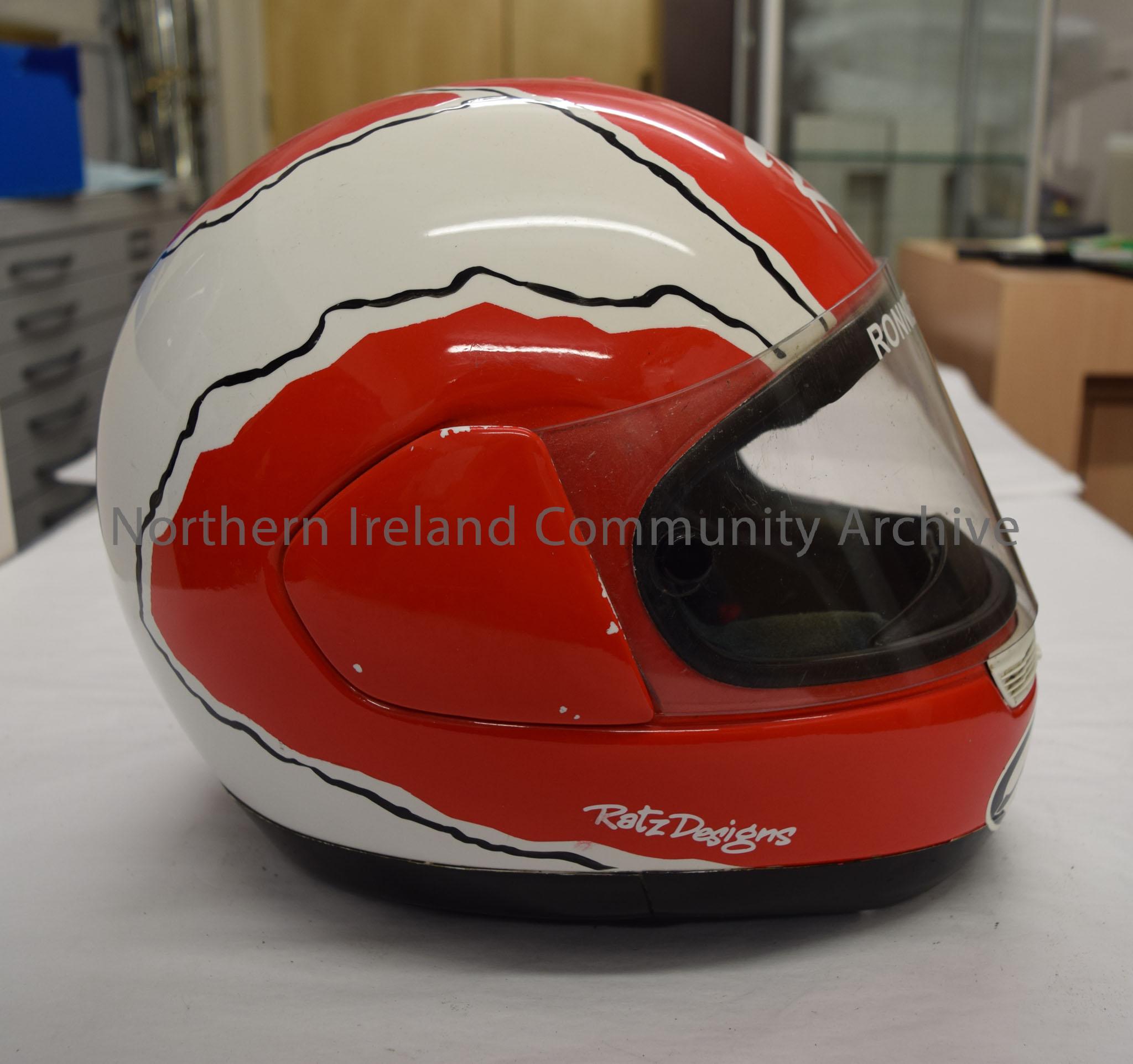 Arai motorcycle helmet belonging to Ronnie Shields. Red and white pattern with thin black lines between and an image of the cartoon character Road Run… – 2016.104 (5)