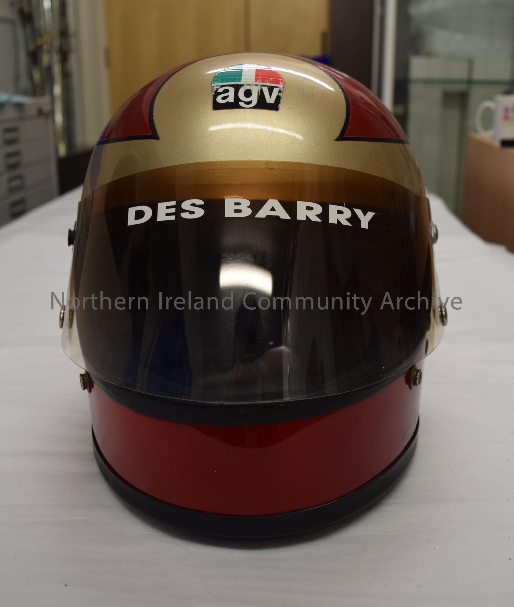 AGV motorcycle helmet belonging to Des Barry. Dark red helmet with gold band around the middle with black trim and tinted visor. – 2016.14 (2)