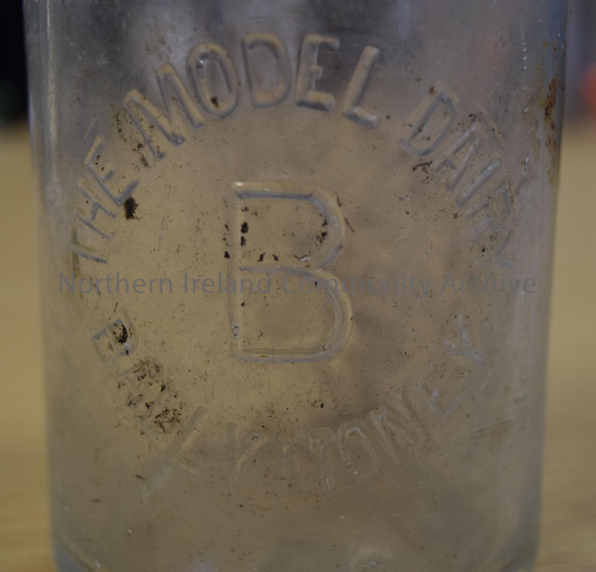 Clear glass milk bottle from the Model Dairy, Ballymoney. – 2016.159 (2)