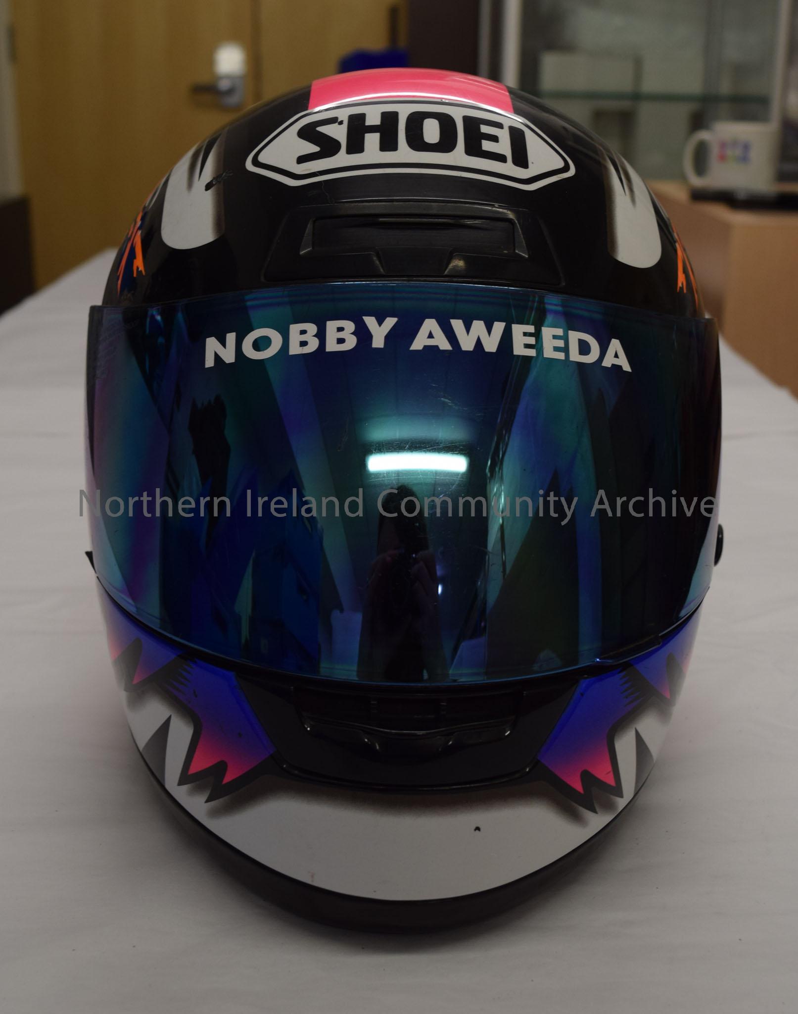 Shoei motorcycle helmet belonging to Nobby (Noboru) Ueda. Electric pink, purple, black and white patterns with Orange and bright yellow barbed wire an… – 2016.17 (2)
