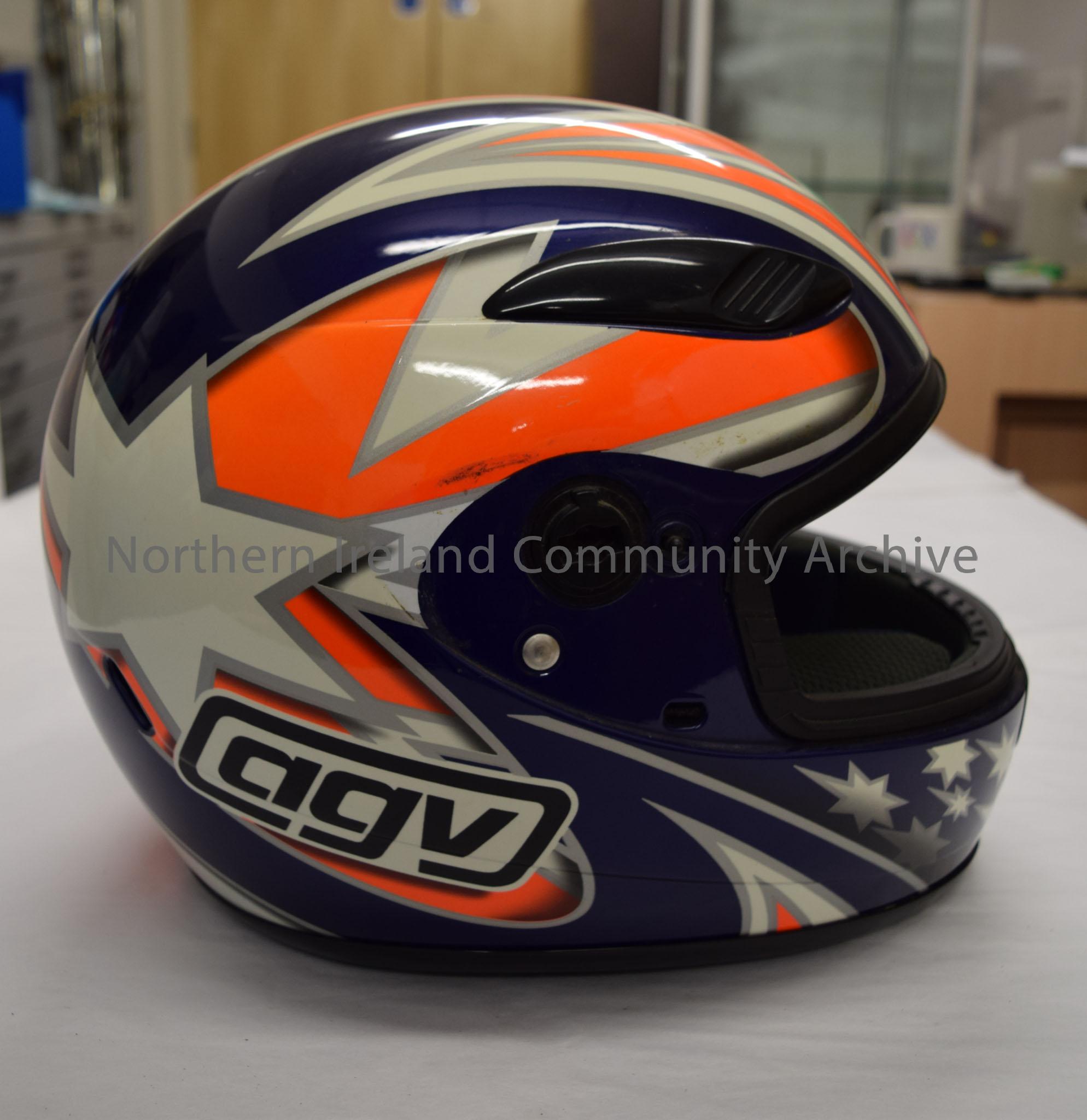 AGV motorcycle helmet. Navy blue with bright orange and white pattern with silver trim and white stars on the chin bar. – 2016.20 (5)
