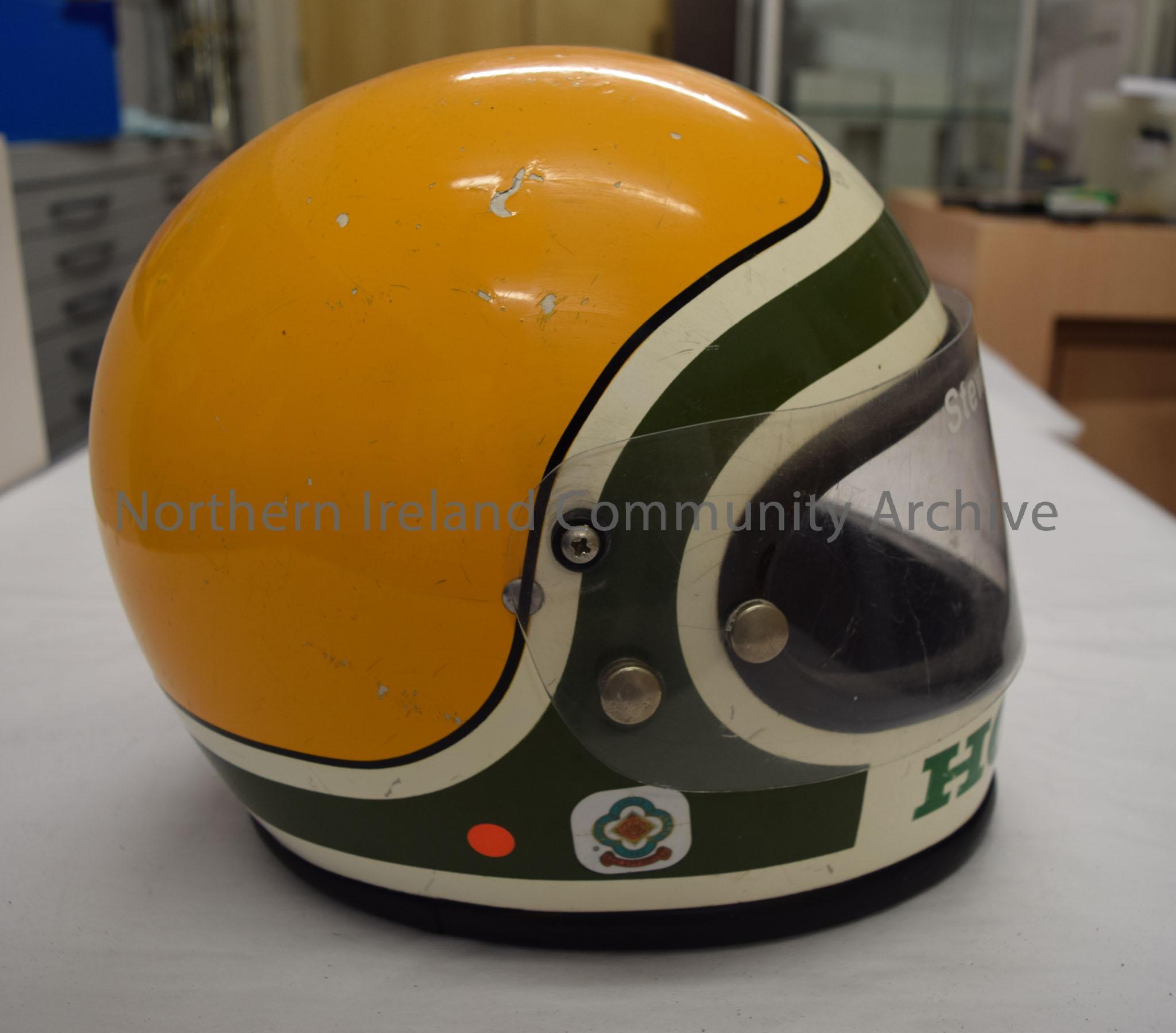Honda motorcycle helmet belonging to Stewart Anderson. White helmet with green stripe and yellow back and sides. – 2016.47 (5)