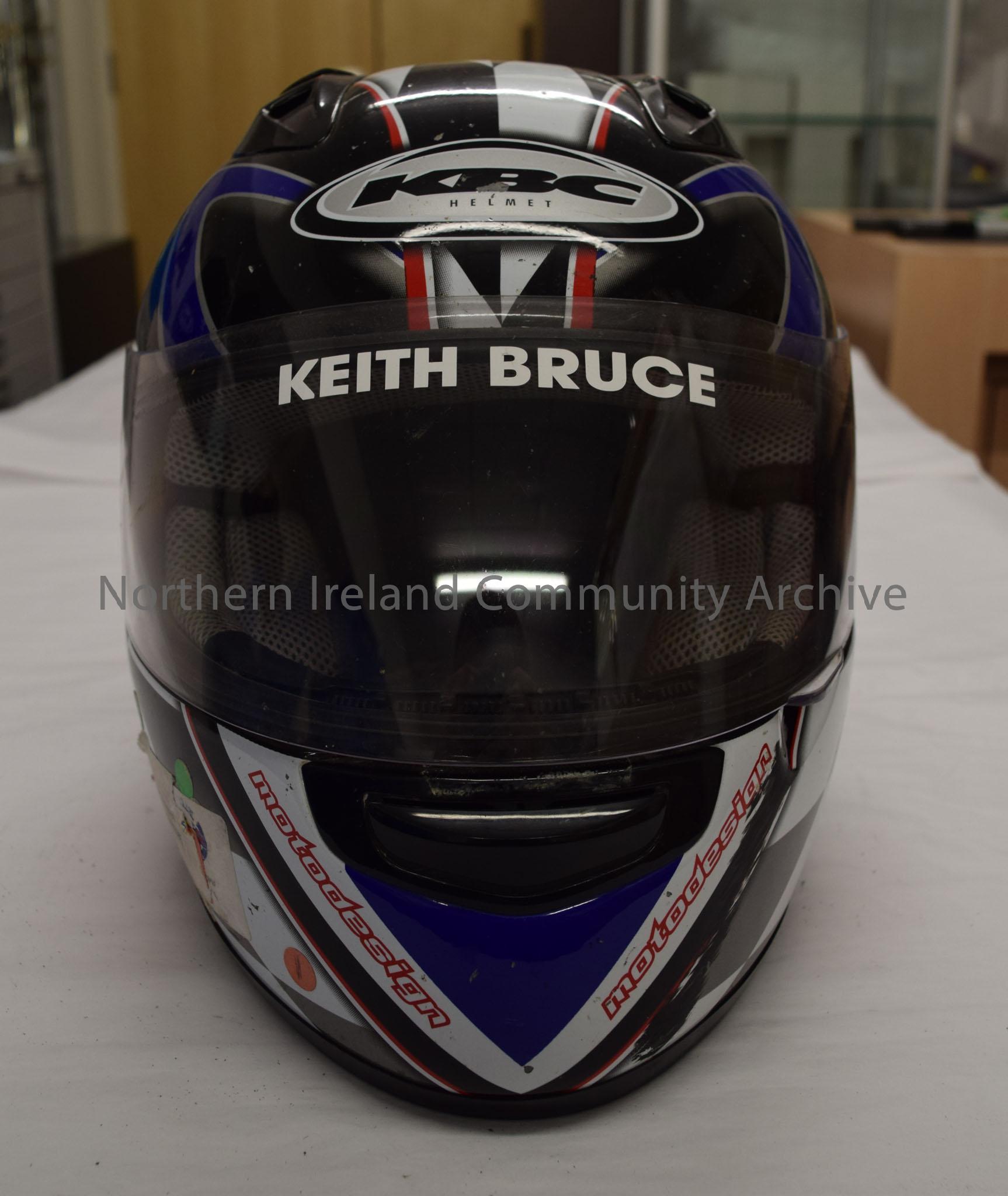 KBC motorcycle helmet belonging to Keith Bruce. Black and white chequered pattern with blue and red stripes. – 2016.75 (2)