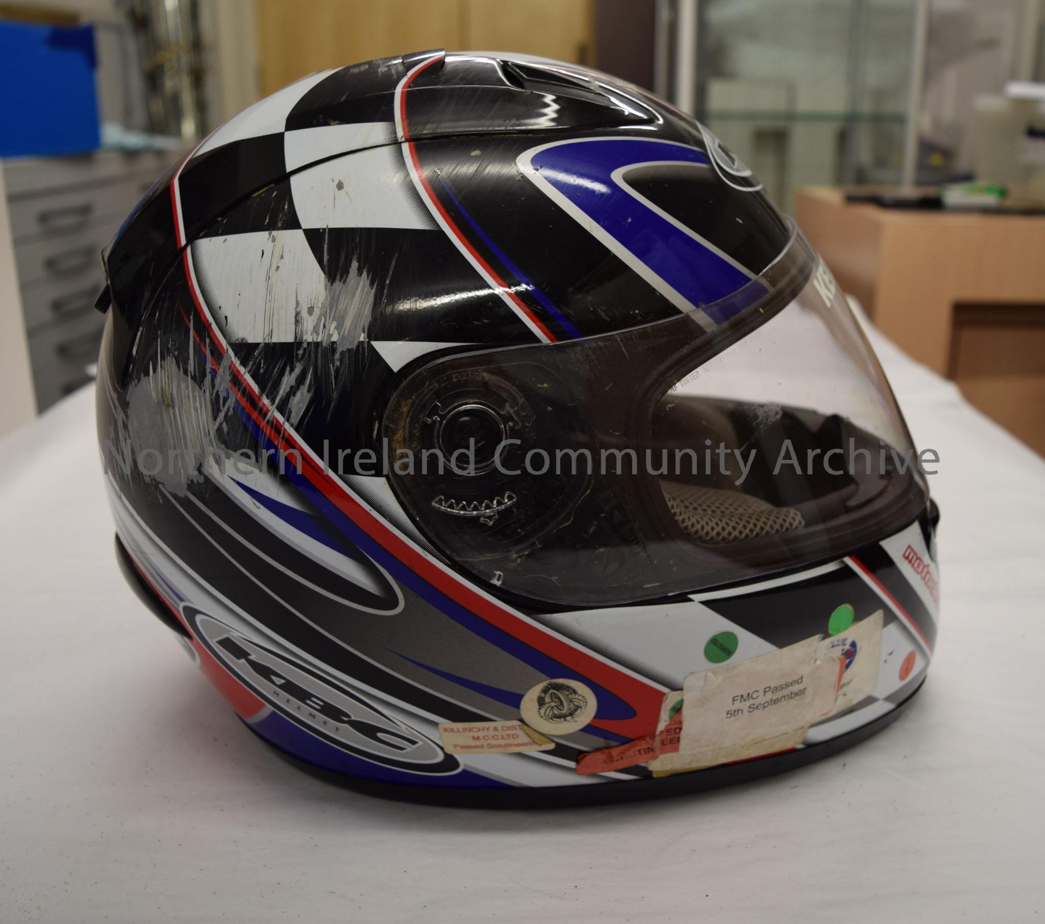 KBC motorcycle helmet belonging to Keith Bruce. Black and white chequered pattern with blue and red stripes. – 2016.75 (5)