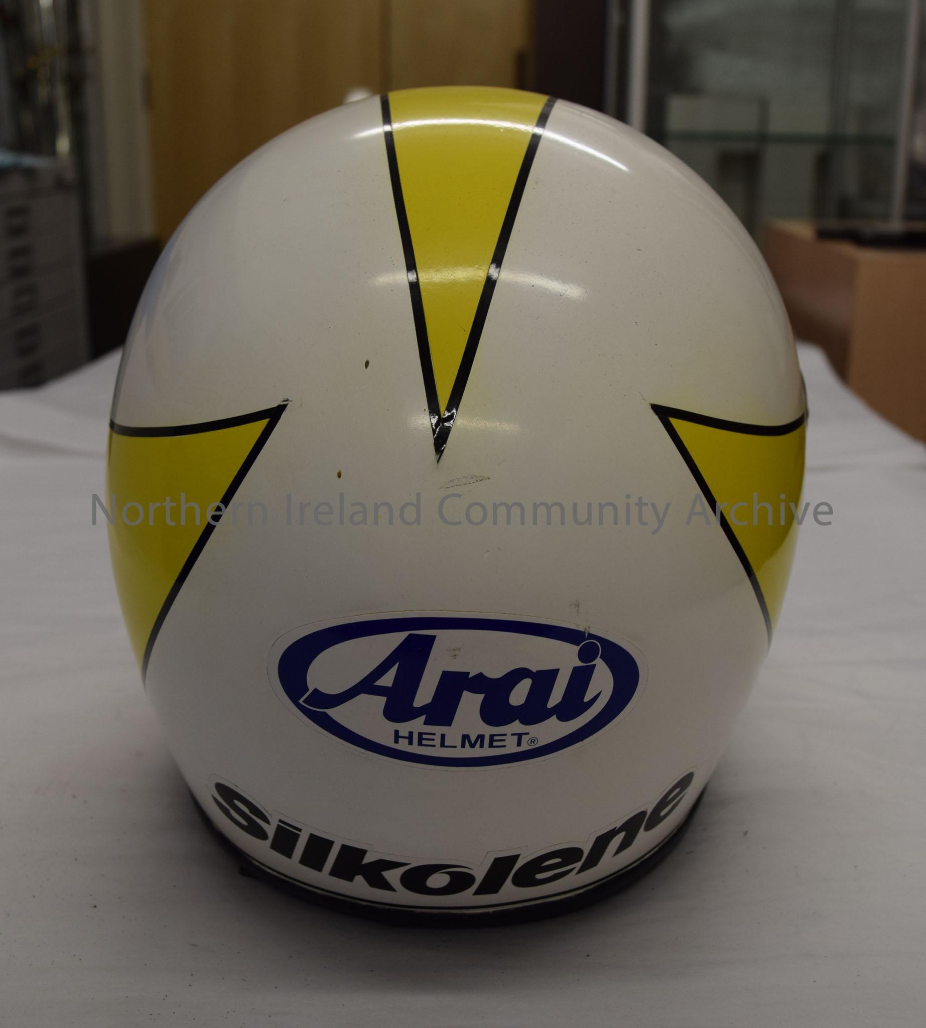 Arai motorcycle helmet belonging to Johnny Dunn. White with yellow front that reaches back to three points. Has a black border. – 2016.79 (4)