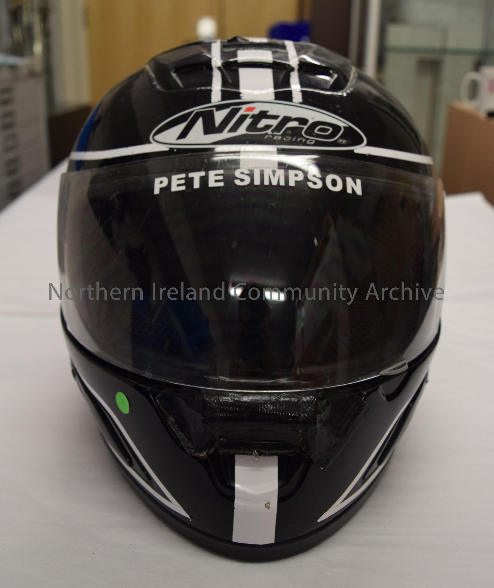 Nitro Racing motorcycle helmet belonging to Pete Simpson. Black with three white stripes down the middle and white trim. – 2016.8 (2)