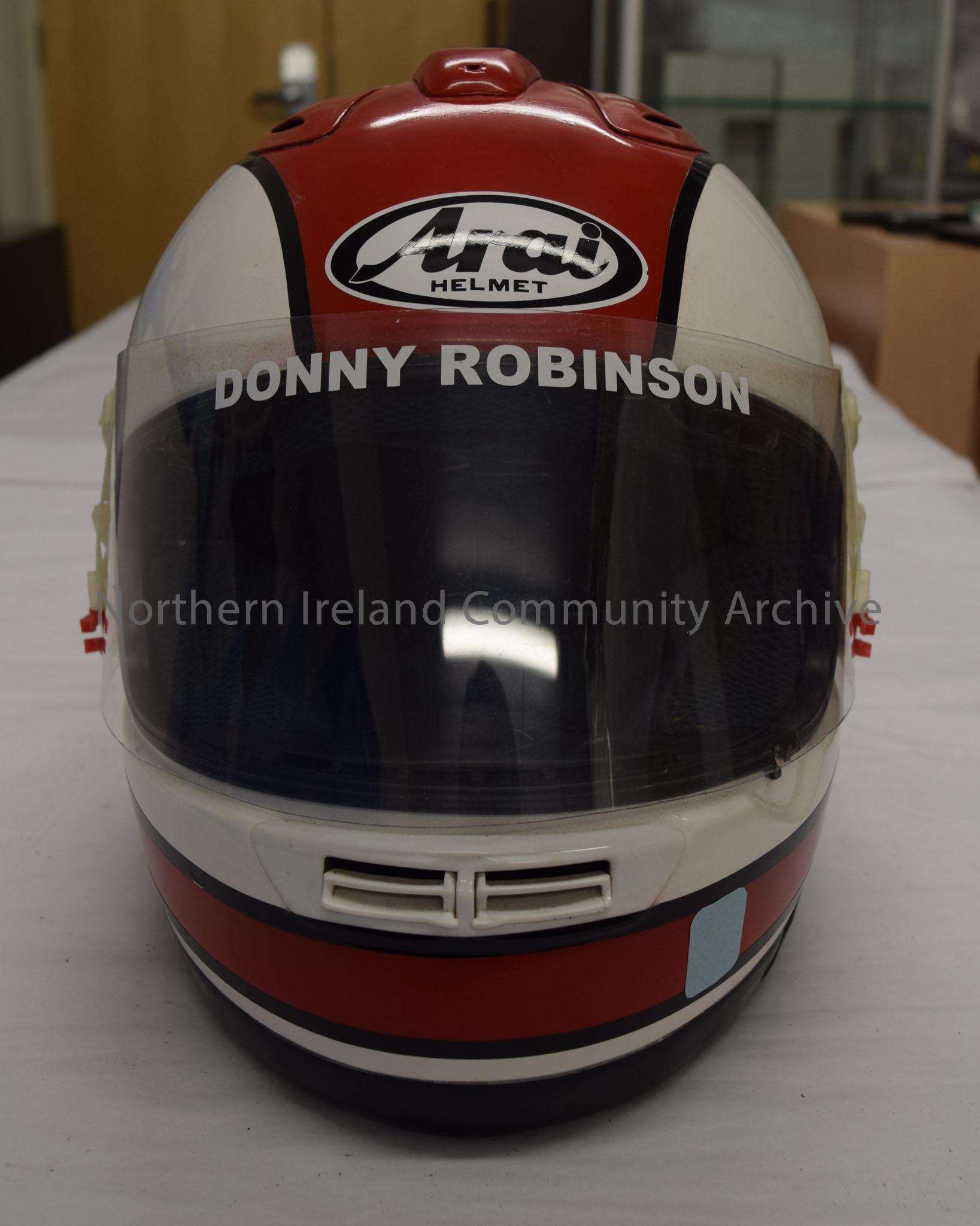 Arai motorcycle helmet belonging to Donny Robinson. White helmet with red stripe with black border running across the top and around the bottom. – 2016.83 (2)