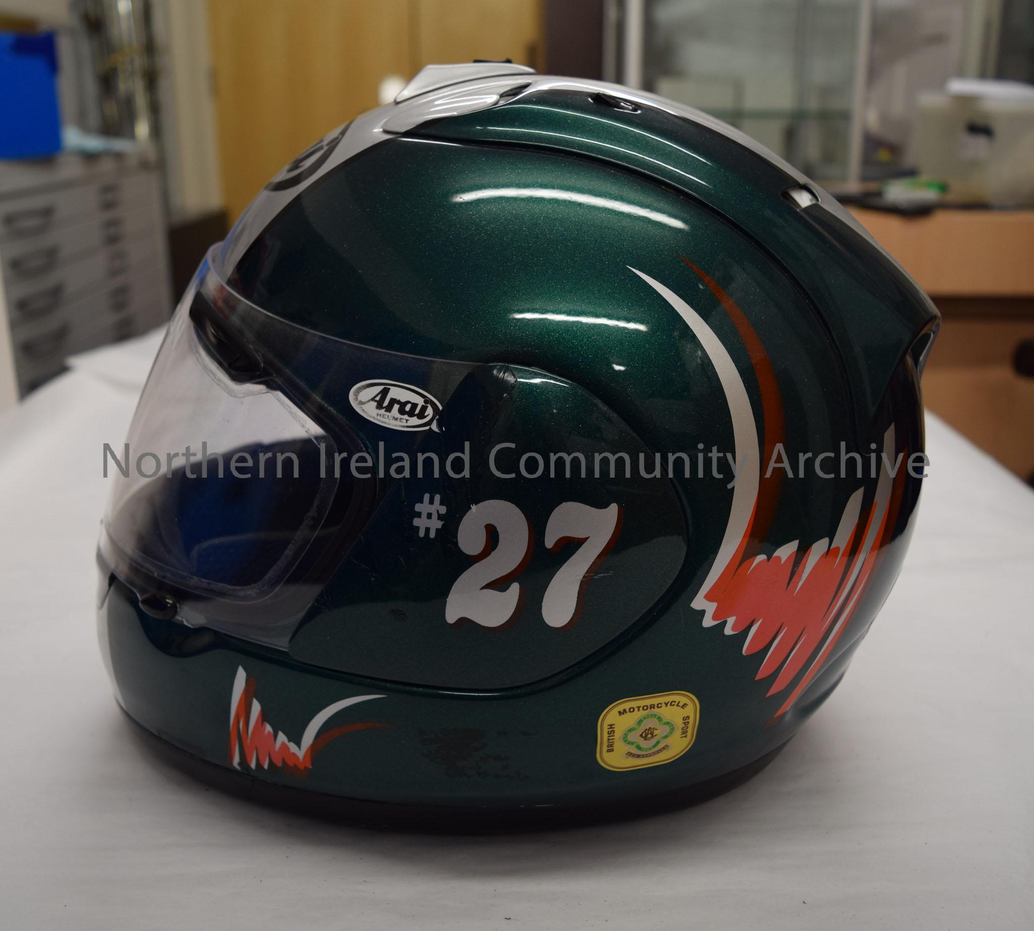Arai motorcycle helmet belonging to James McCann. Dark green with silver stripes down the middle, orange squiggle on the side and an image of the cart… – 2016.85 (3)