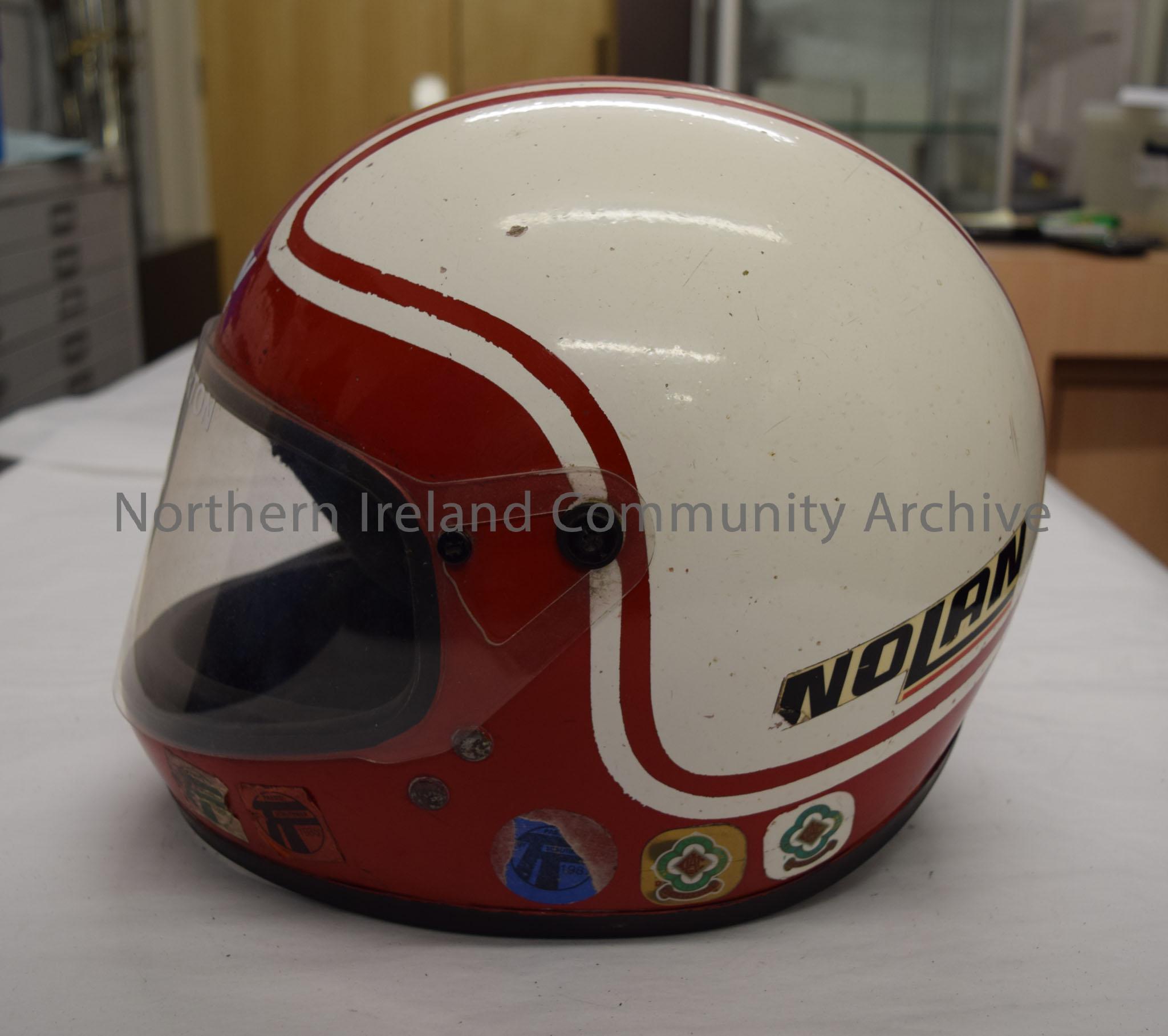 Nolan motorcycle helmet belonging to Mick Chatterton. White helmet with red front and a red stripes going down the middle and around the bottom. – 2016.96 (3)
