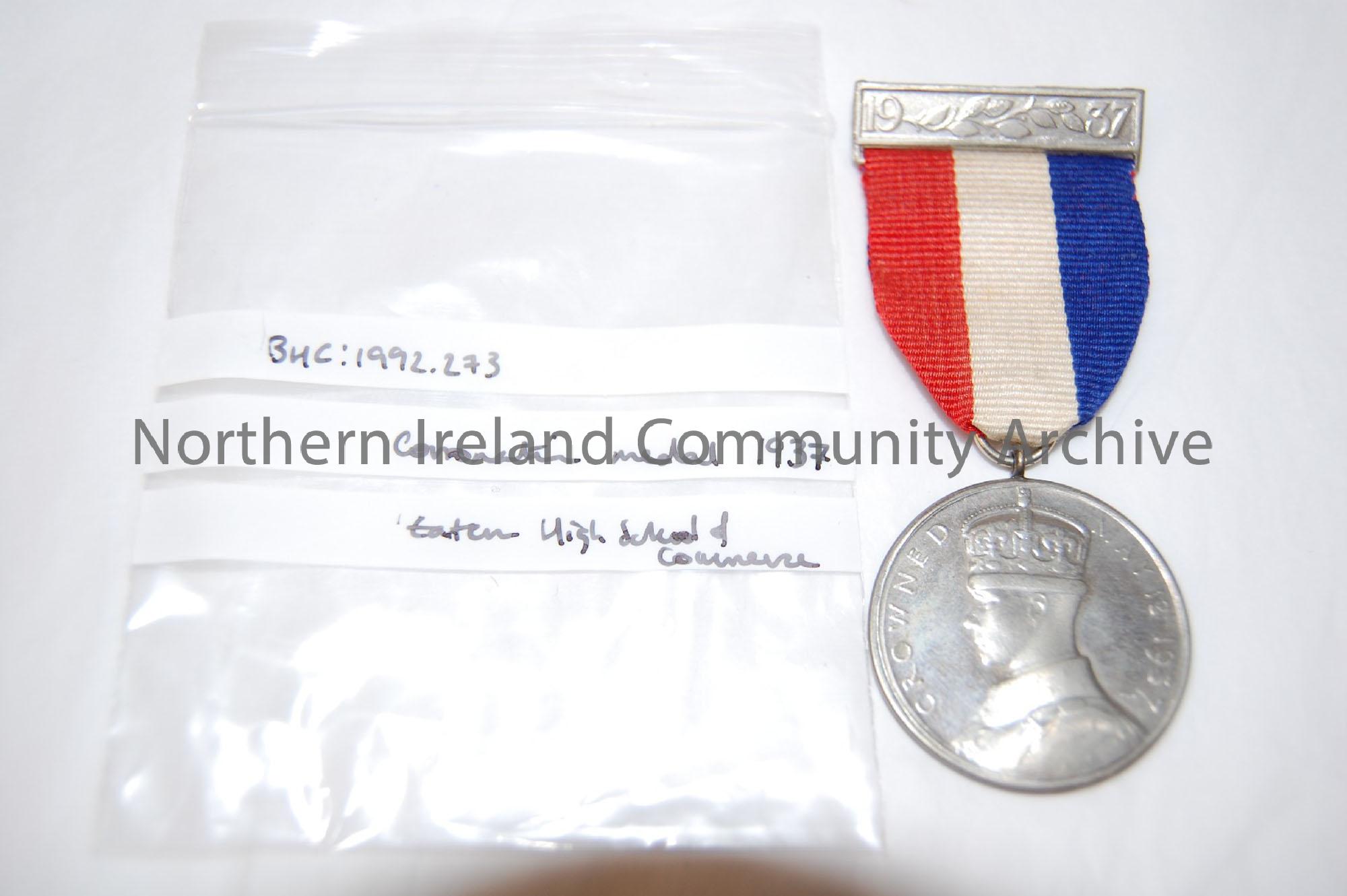 King George VI Coronation medal. Silver coloured base metal medal with original red, white,and blue ribbon with original pin.