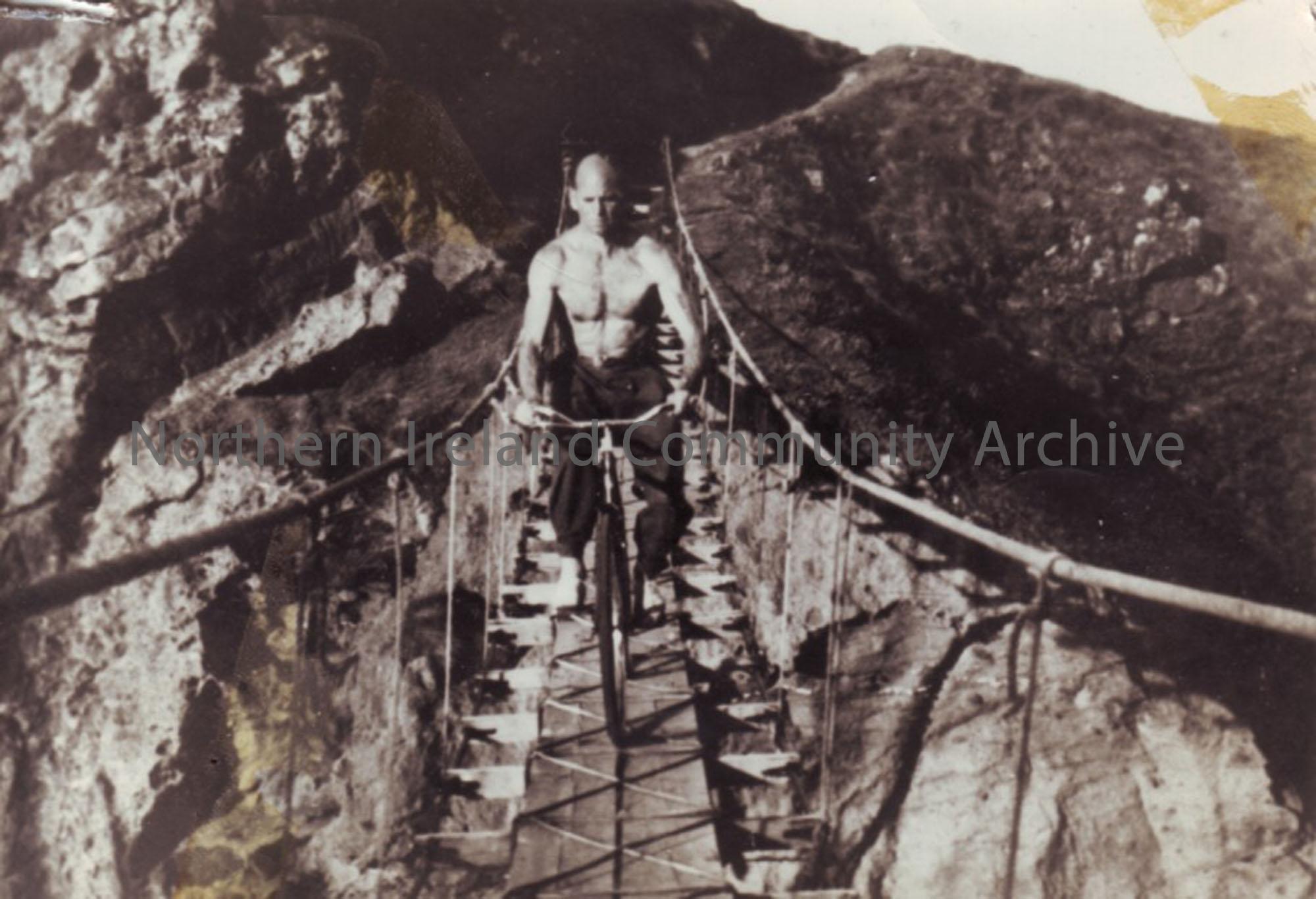 Leslie McCurdy, Athlete riding a bike across Carrick-a-Rede rope-bridge –  NI Archive