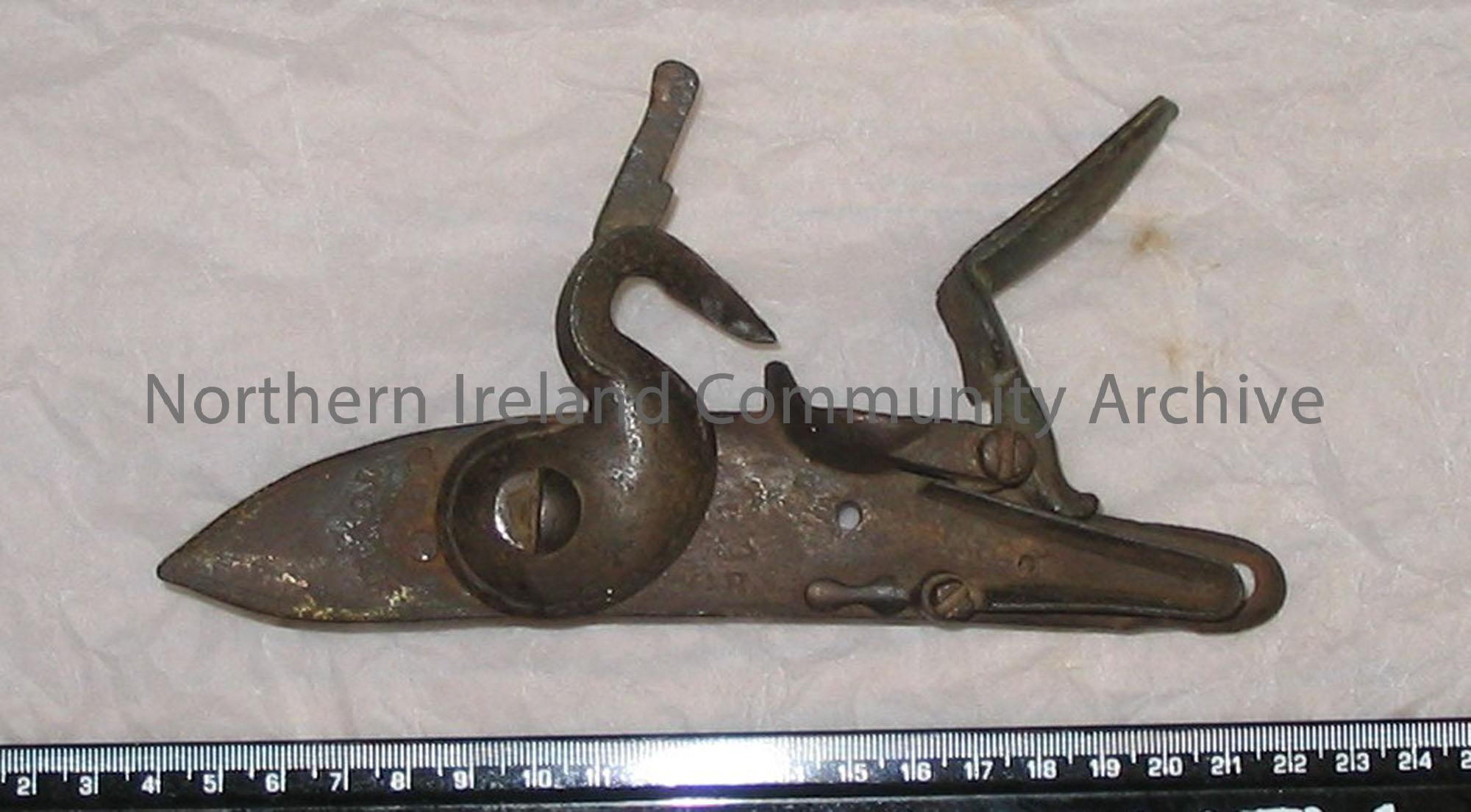 The mechanism for a flint lock musket rifle, possibly a ‘Brown Bess’; almost complete, except that the upper fixing to hold the flint is missing; guns…