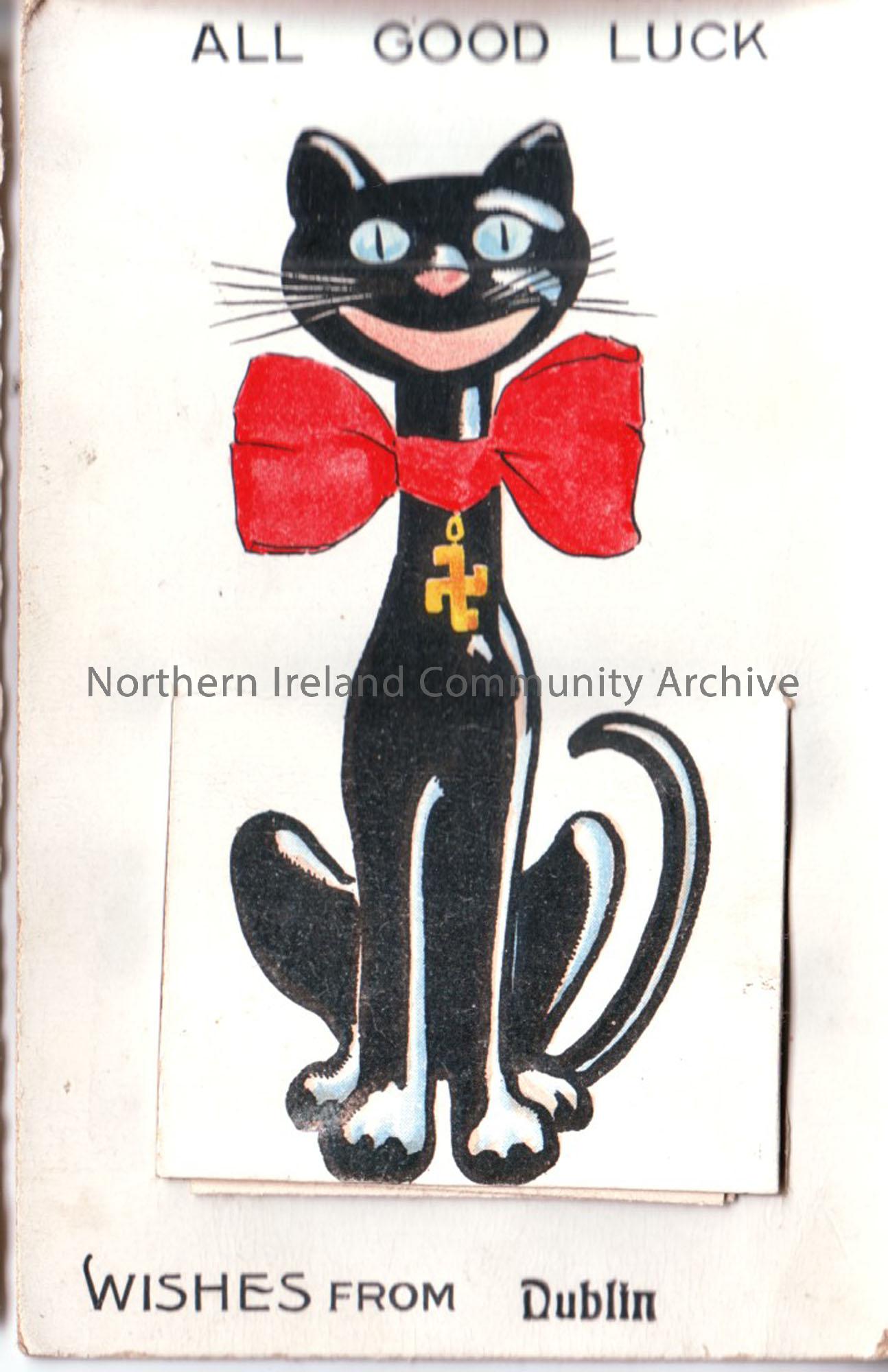 Black cat with red bow and a ‘swaztika’ good luck symbol. A flap on the front lifts up to reveal a series of fold-up images of Dublin. It is addressed…
