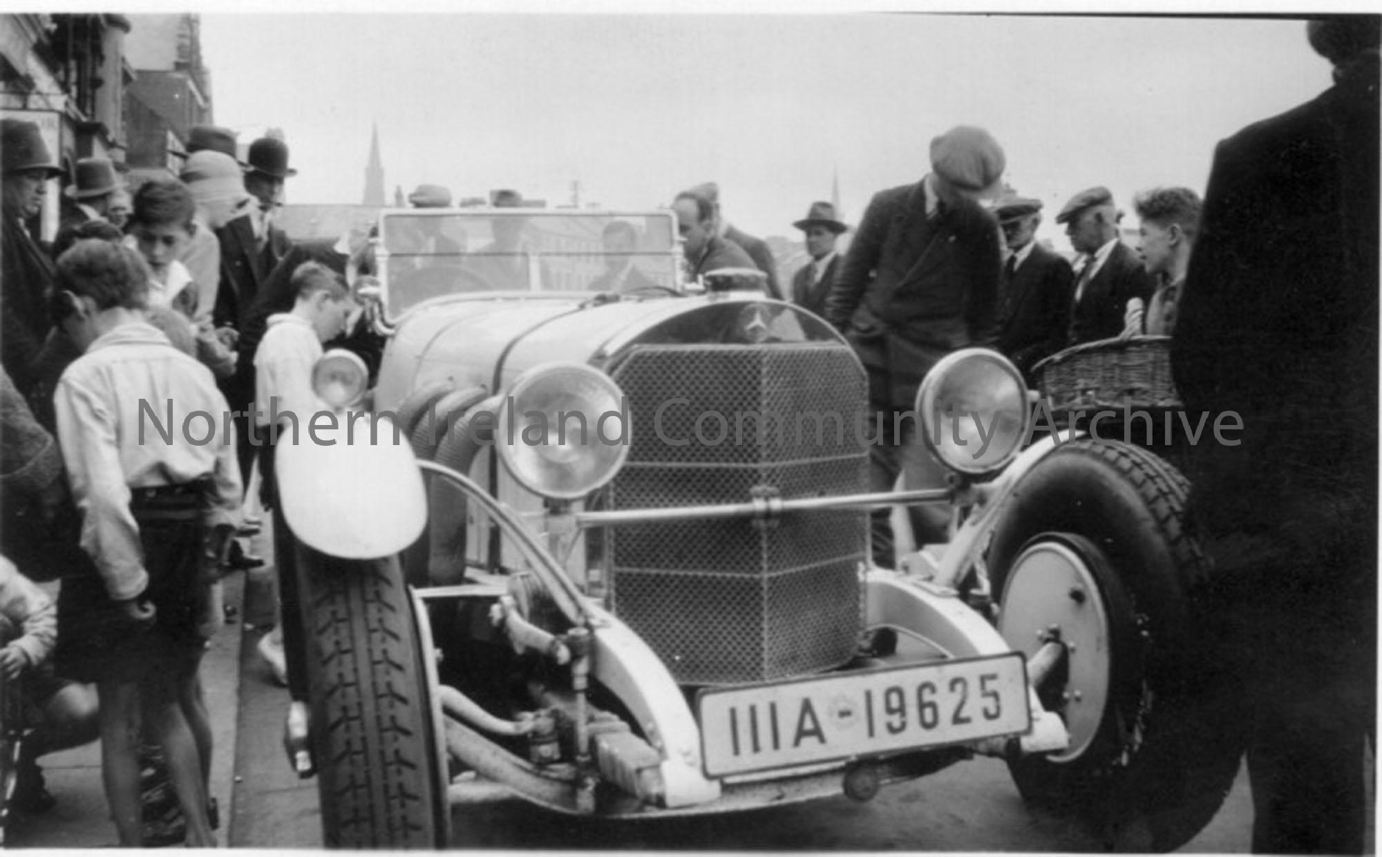 Crowds gather around a car belonging to Austin Prince, which raced in the Ulster TT. No. Plate, IIIA 19625