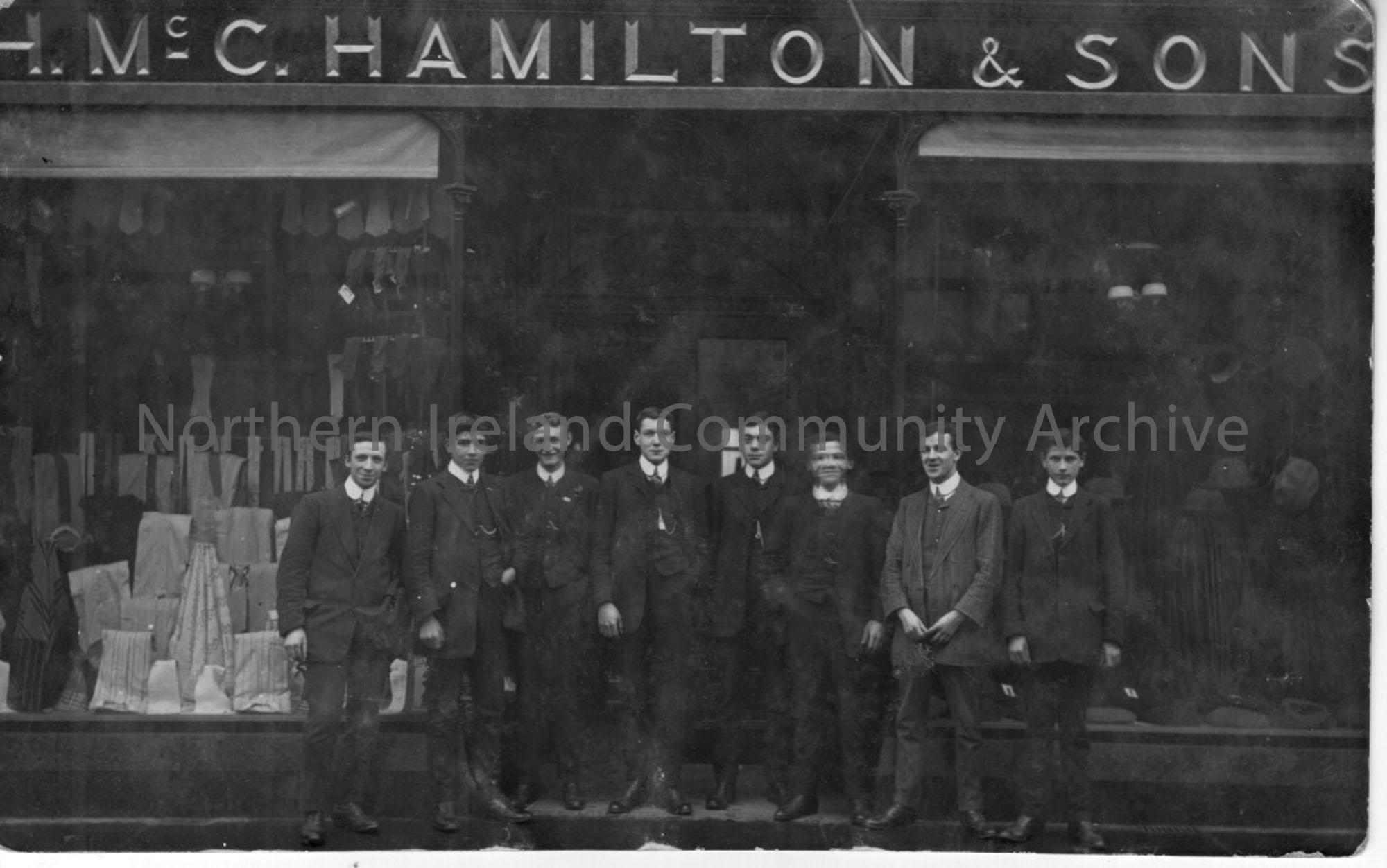 Eight young men stand outside Hamilton McCurdy Hamilton and Sons’ store on Church street, Ballymoney