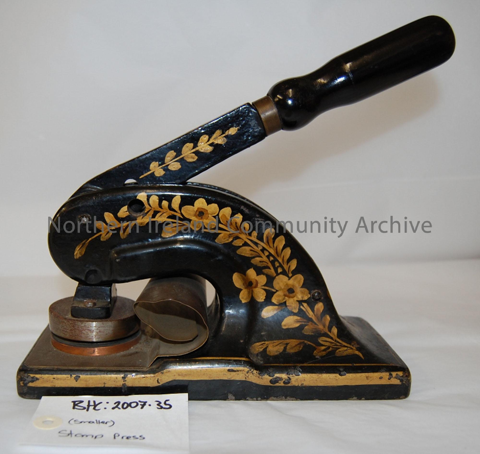‘Ballymoney Board of Guardians’ stamp press from Ballymoney Town Hall. Painted black with gold painted leaf/flower design. Black painted wooden handle…