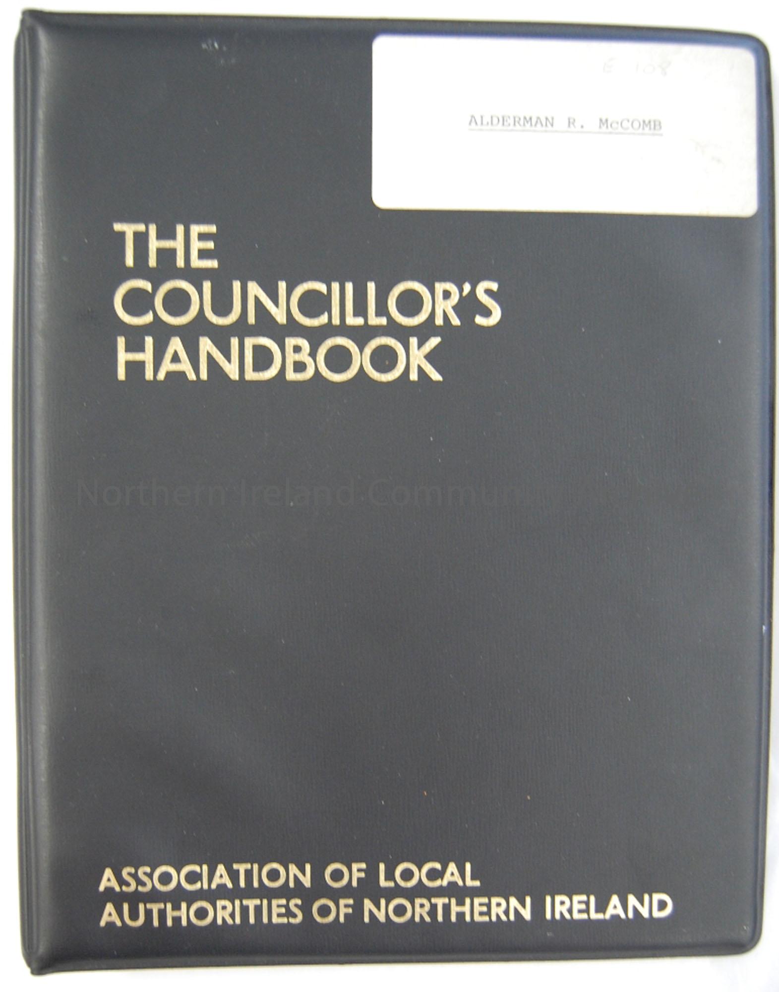 Small black ring binder file named The Councillor’s Handbook.