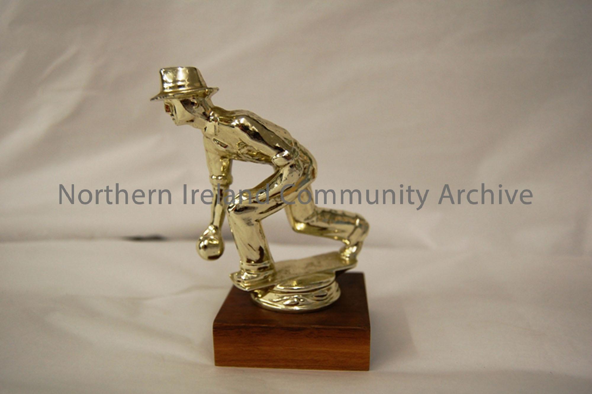 Bowling trophy- brass statue of a man bowling mounted on a wooden plinth