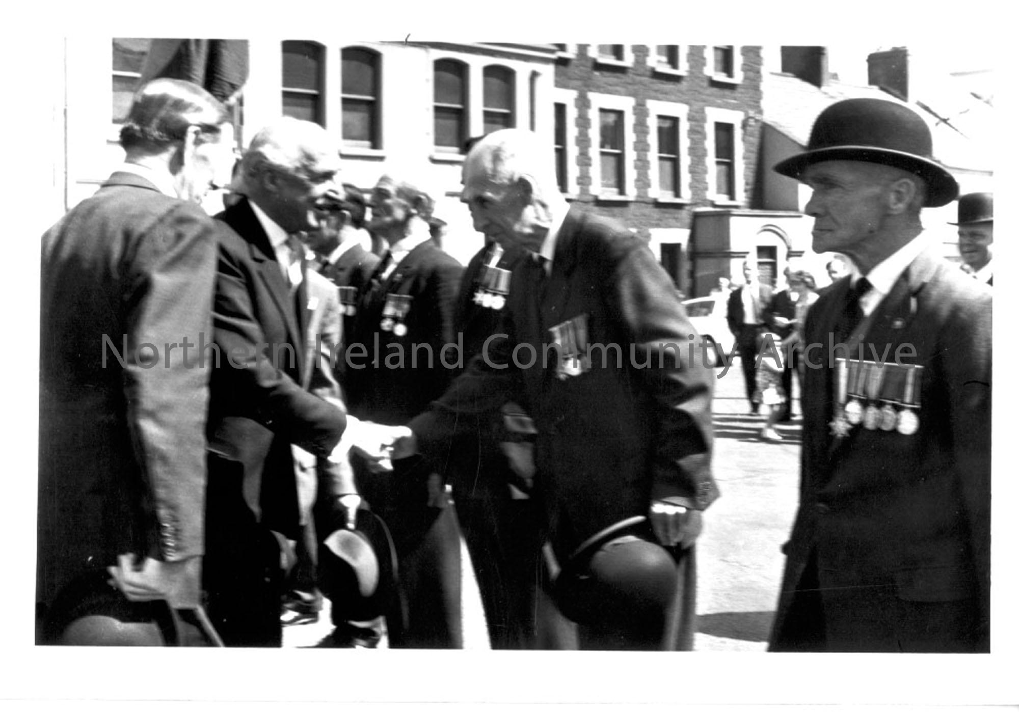Photographic print of War veterans meeting and shaking hands with Lord Erskine