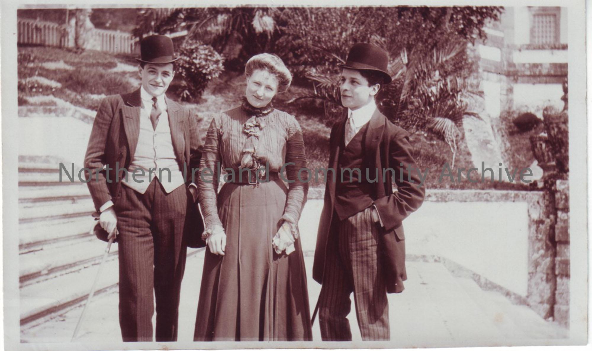 two young men in bowler hats and a lady