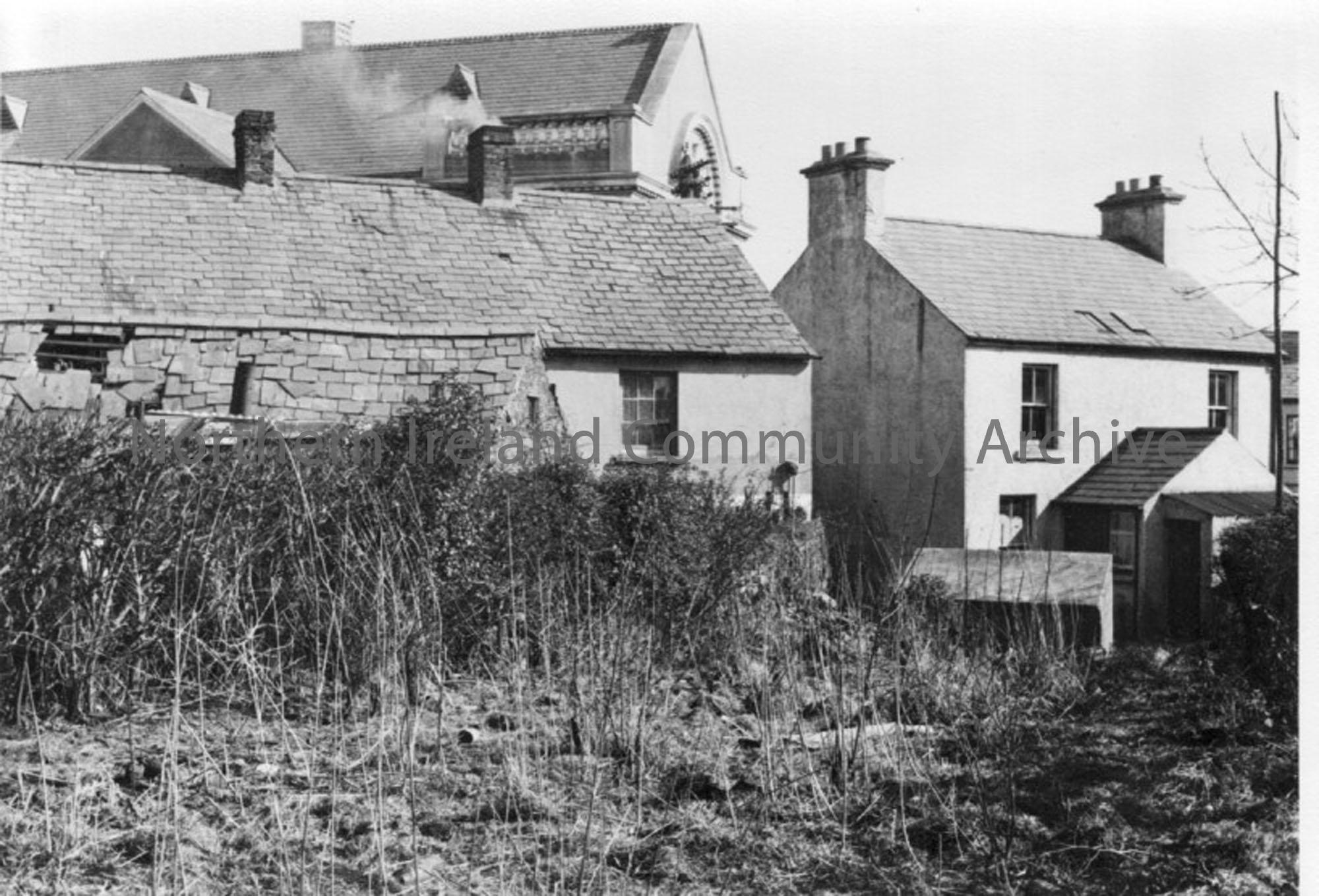 black and white photographs depicting terraced houese, backyards, carparks, come scenes of dilapidation C. 1950’s. Handwritten note included indicates…