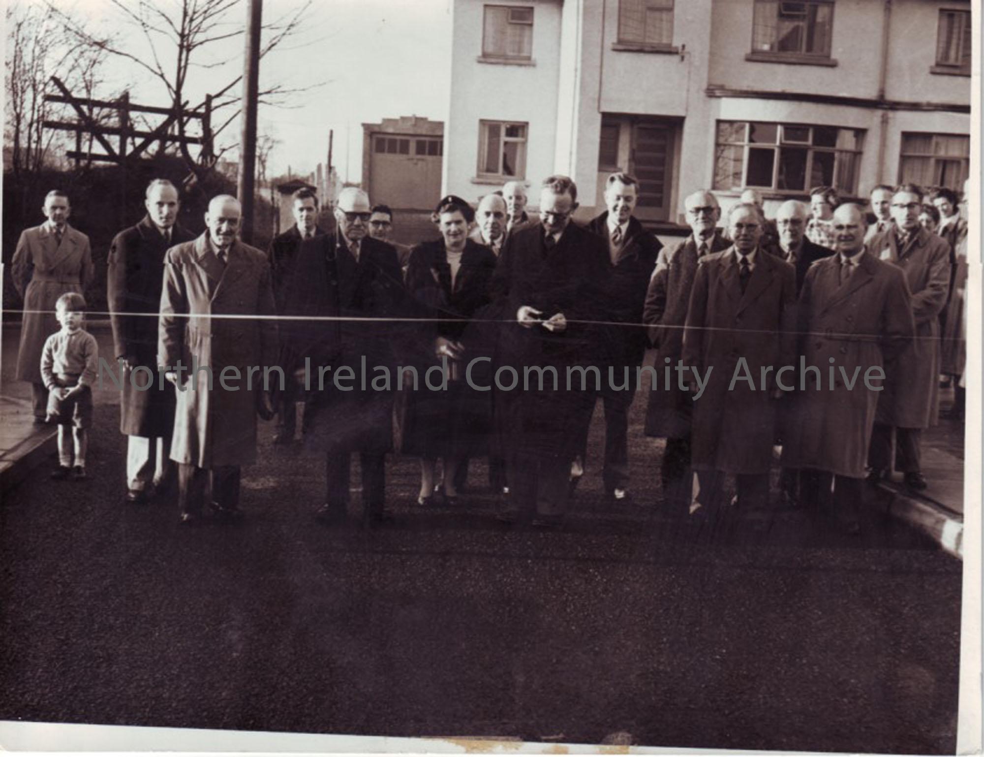 black and white photograph of the cutting of the ribbon at an opening ceremony, Newal Road houses?
