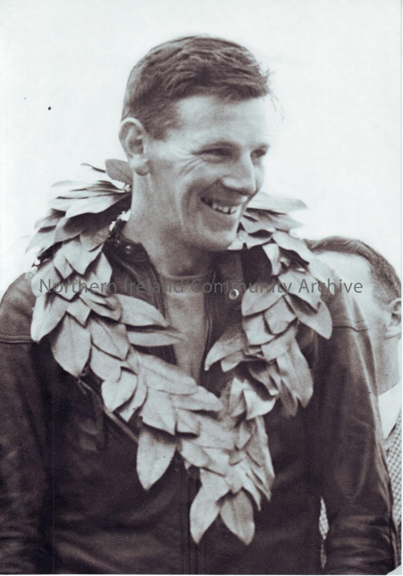 black and white photograph of Richard Creith with wreath around his neck