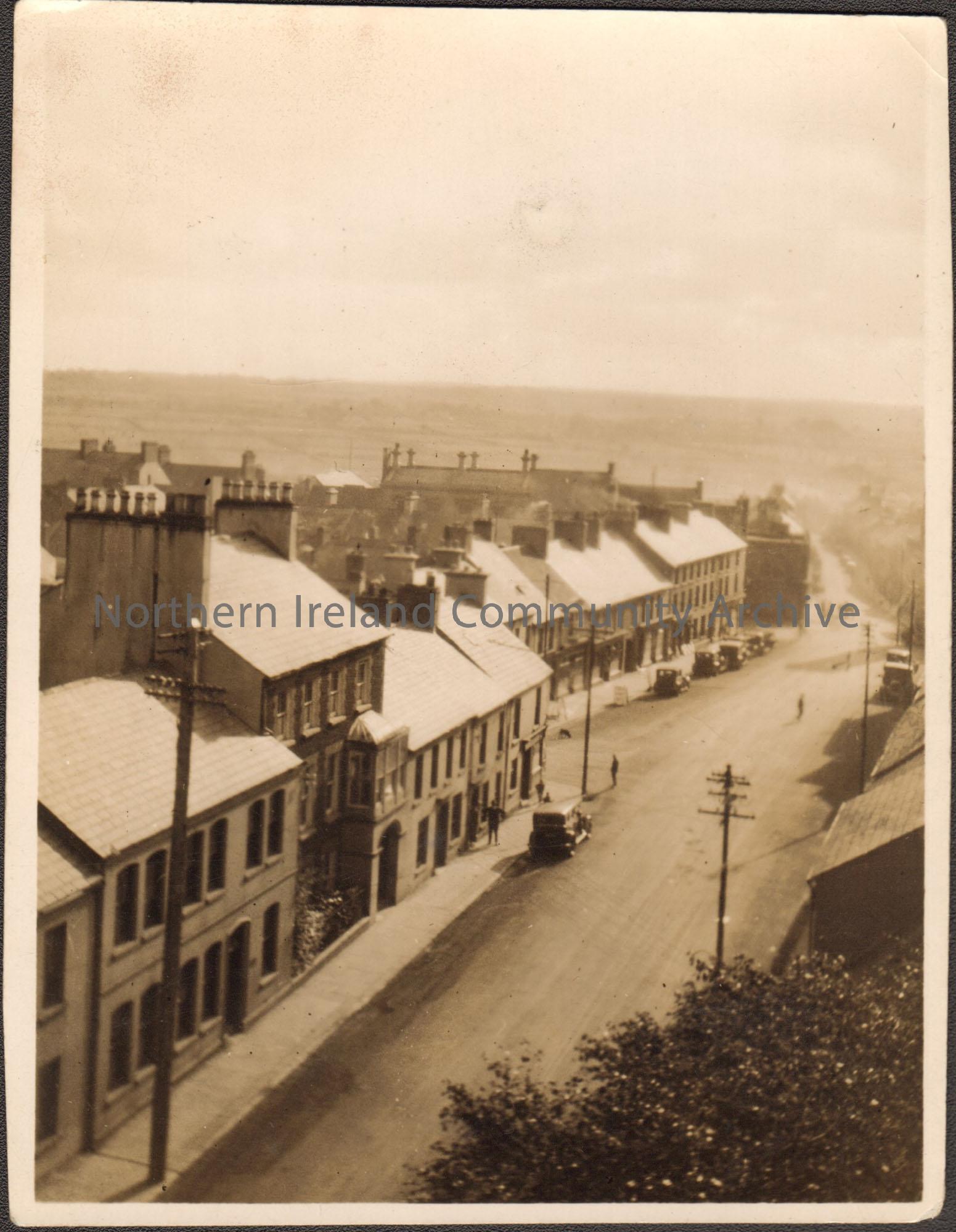 Black and white photograph. View of High Street from above. Main Street in the distance.