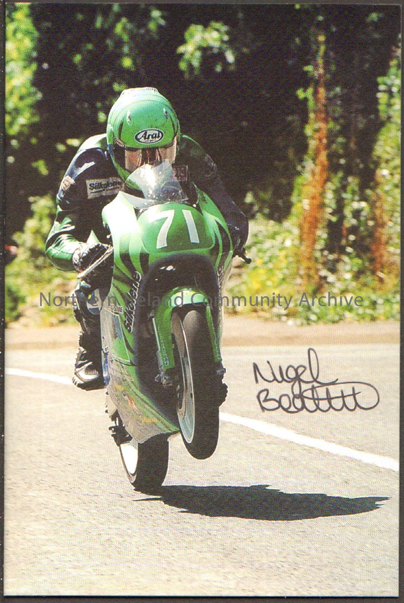Signed photograph of Nigel Beattie riding a green motorbike with number 71 on the front wearing green and blue leathers and a green Arai helmet
