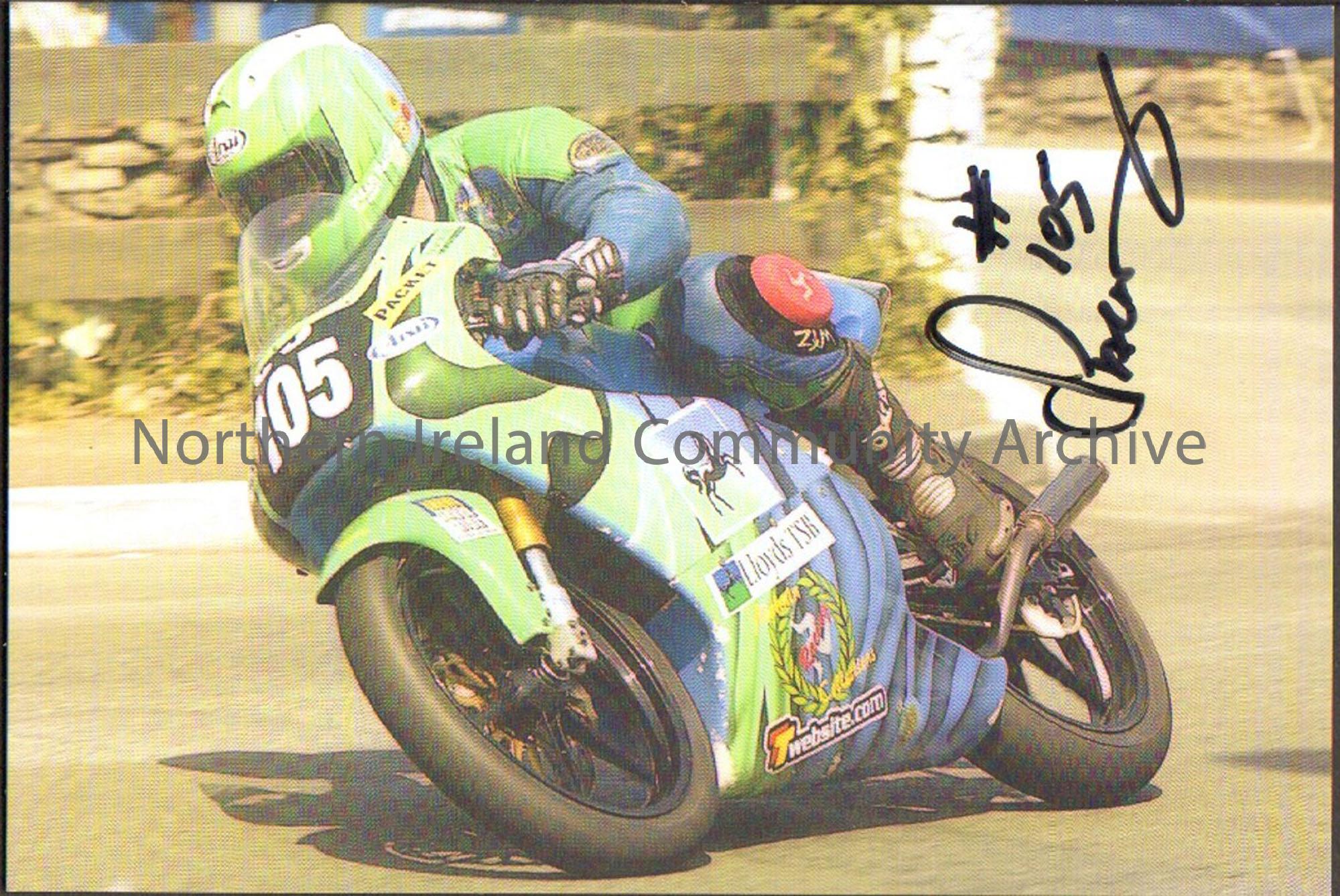 Signed photograph of Chris Palmer riding a blue and green motorbike with number 105 on the front and wearing blue and green leathers riding around a c…