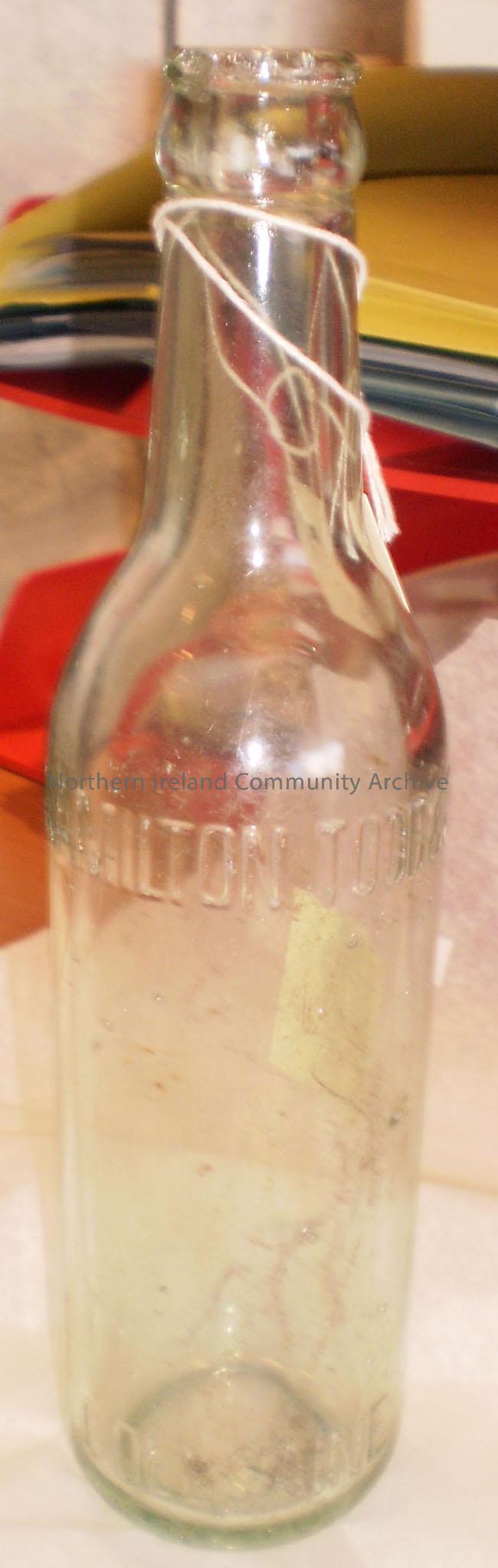 Clear glass bottle. Imprinted on the glass is ‘Hamilton Todd & Co., Coleraine’. Imprinted on the base reads – ‘B79’.