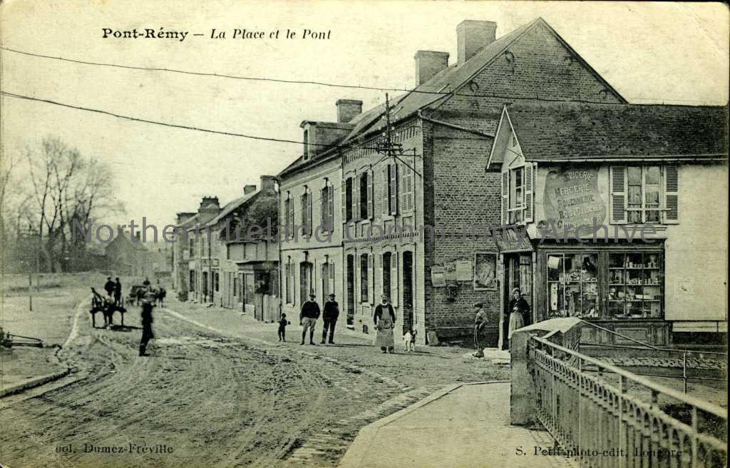 Black and white postcard titled ‘Pont-Remy – La Place et le Pont’. Dated 26.12.1920 on the reverse and there is a handwritten message in French.