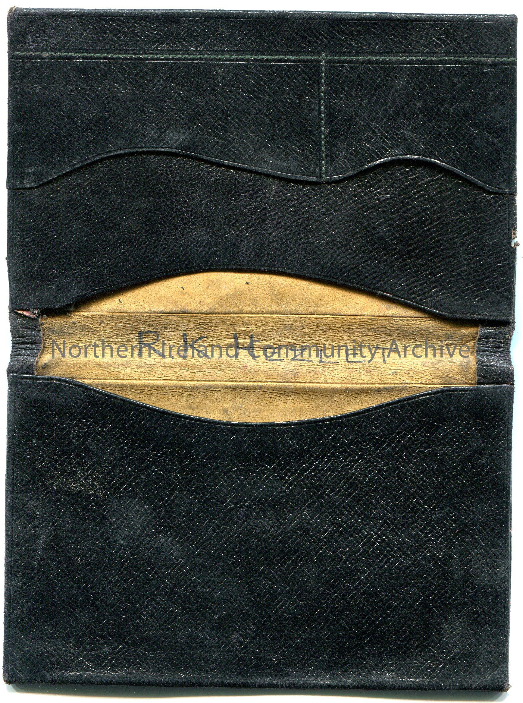 Black, possibly leather, wallet belonging to Robert Knox Hezlet. ‘R K Hezlet’ is handwritten in upper case on inside fold. Comprised of two sides, thr… – scan005b