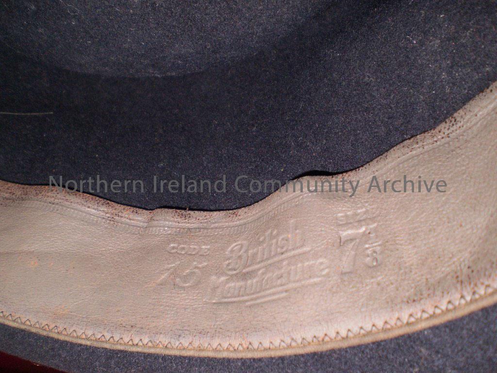 Trilby black hat which belonged to Ronnie Gamble’s father. He was given this when he was demobed from military service. The label on the inside reads … – 1