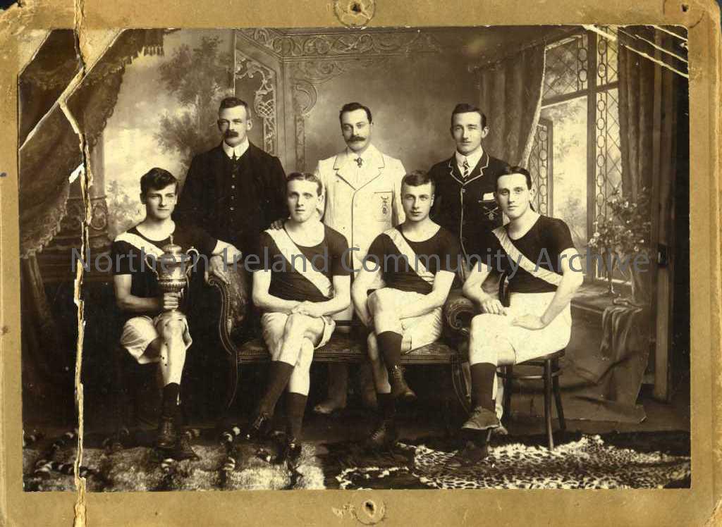 Black and white photograph mounted onto brown card. Reverse reads – ‘River Bann Rowing Club. Frank Hunter front row 3rd from left.’ Centre front – Jac…