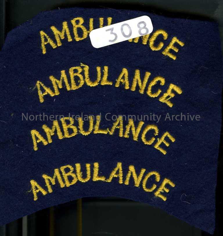 Navy with yellow stitching – ‘Ambulance’. Four on one piece of material.