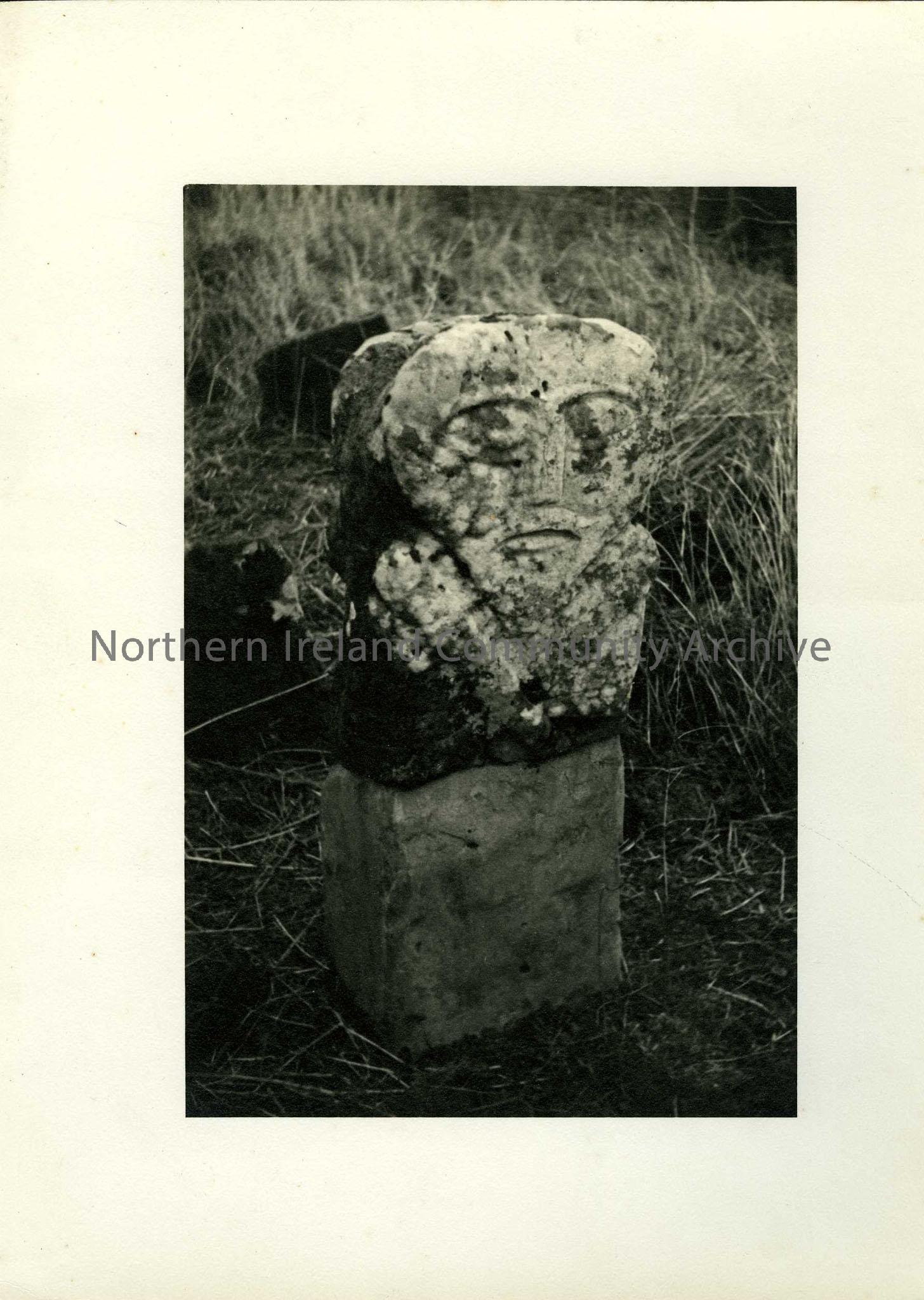 Black and white photograph of carved stone – image of face