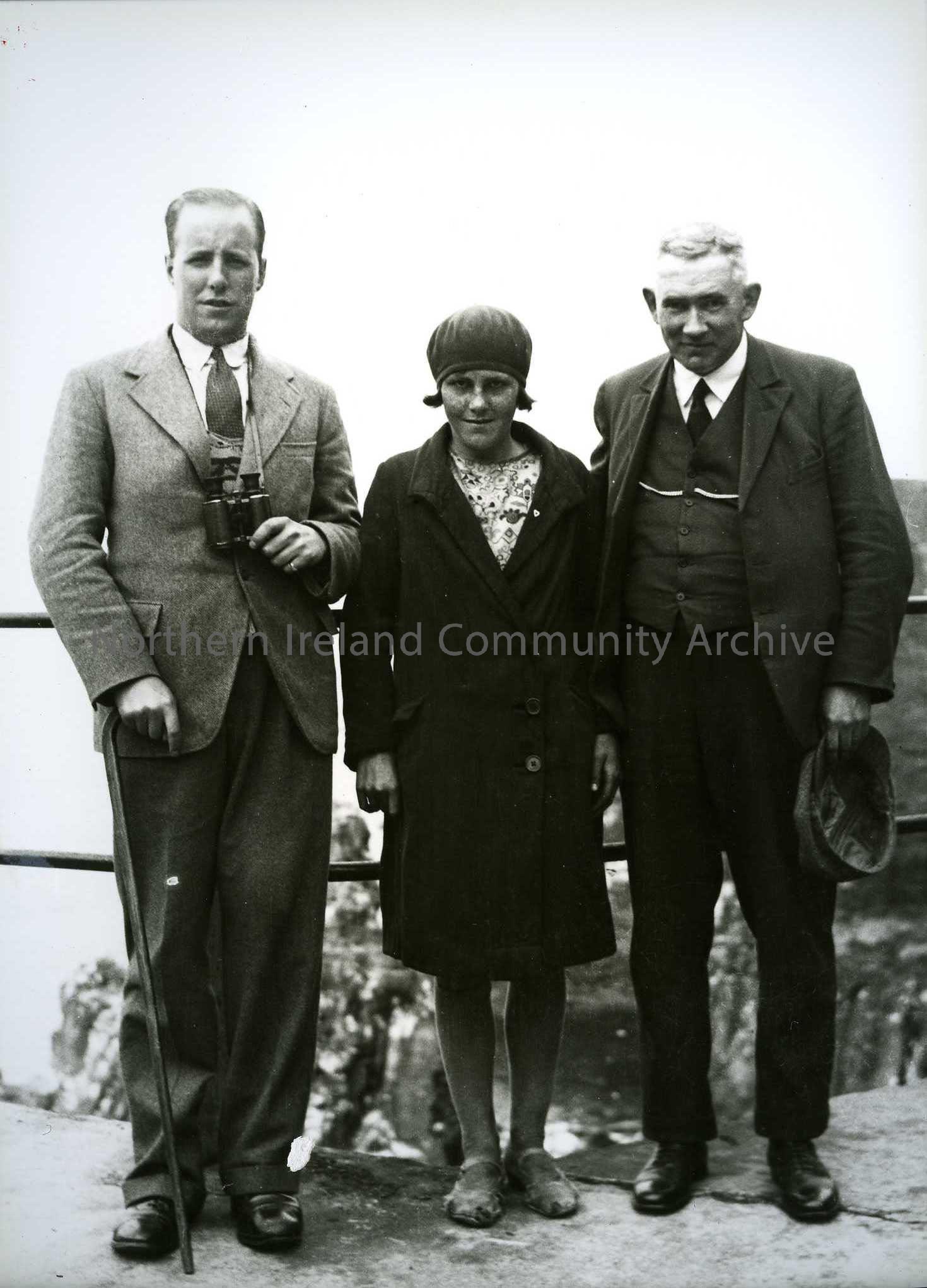 Printed black and white photograph – two men with a young girl, Rosie McFaul. According to John Moulden, man on right is Johnnie Martin